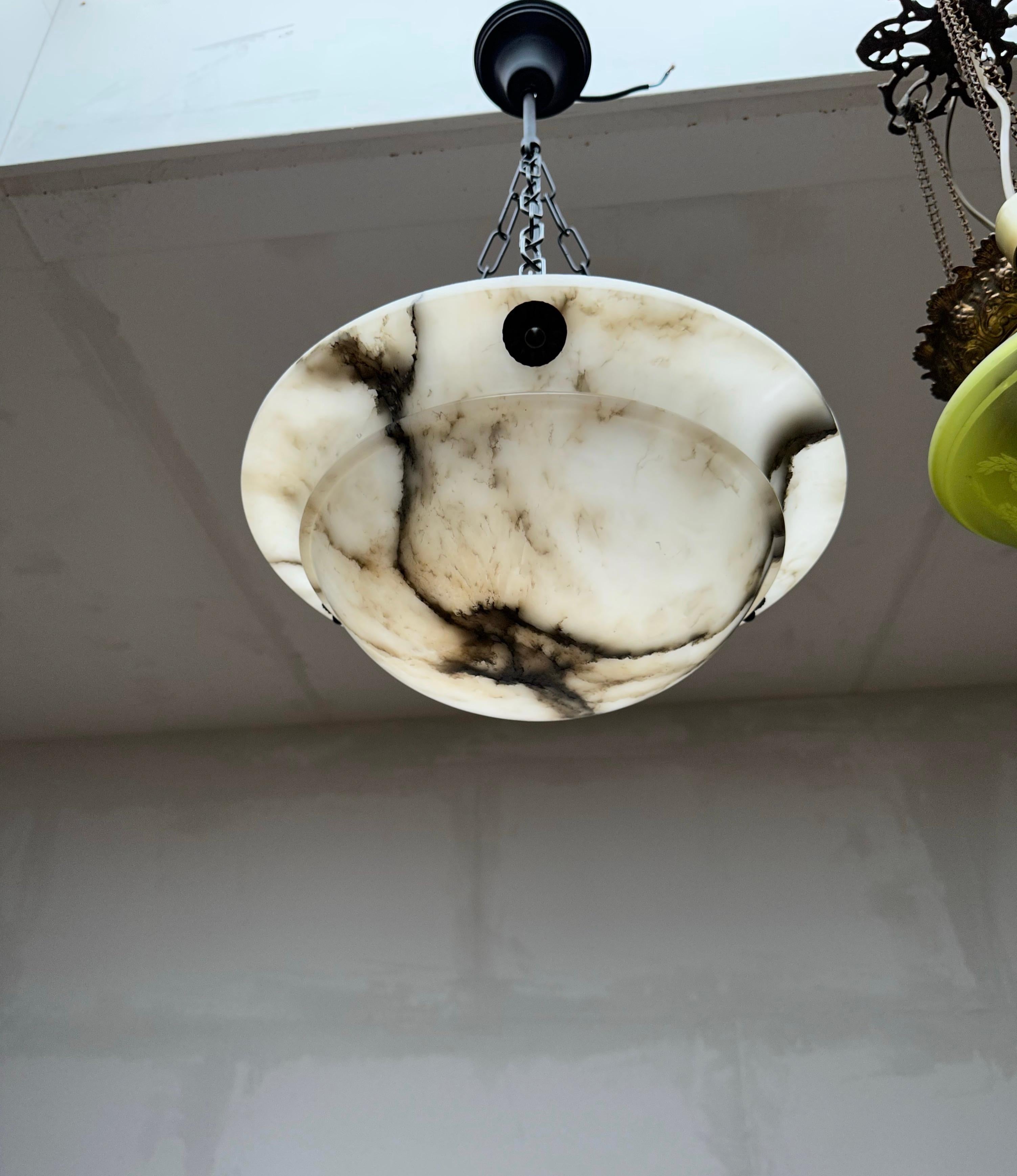 Stunning and practical size, alabaster pendant of great quality and good condition.

This rare fixture from the heydays of the European Art Deco era could soon be lighting up your days and evenings. Its remarkable, circular and layered shade is all