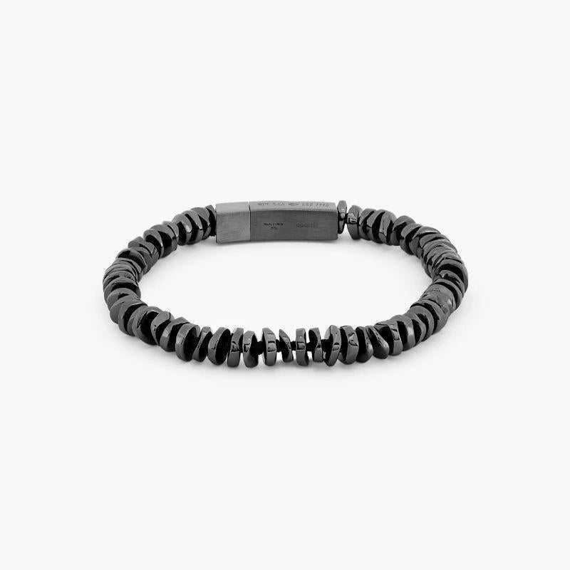 Pure Click Bead Bracelet in Black Rhodium Plated Sterling Silver, Size L

Irregular shaped, hand-polished silver discs sit stacked together to create a harmonious, multi-layered piece. Set on black thread, with our iconic square click clasp,