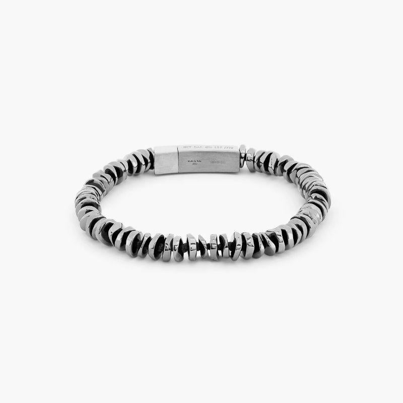 Pure Click Bead bracelet in Sterling Silver, Size L

Irregular shaped, hand-polished silver discs sit stacked together to create a harmonious, multi-layered piece. Set on black thread, with our iconic square click clasp, meticulously engineered in