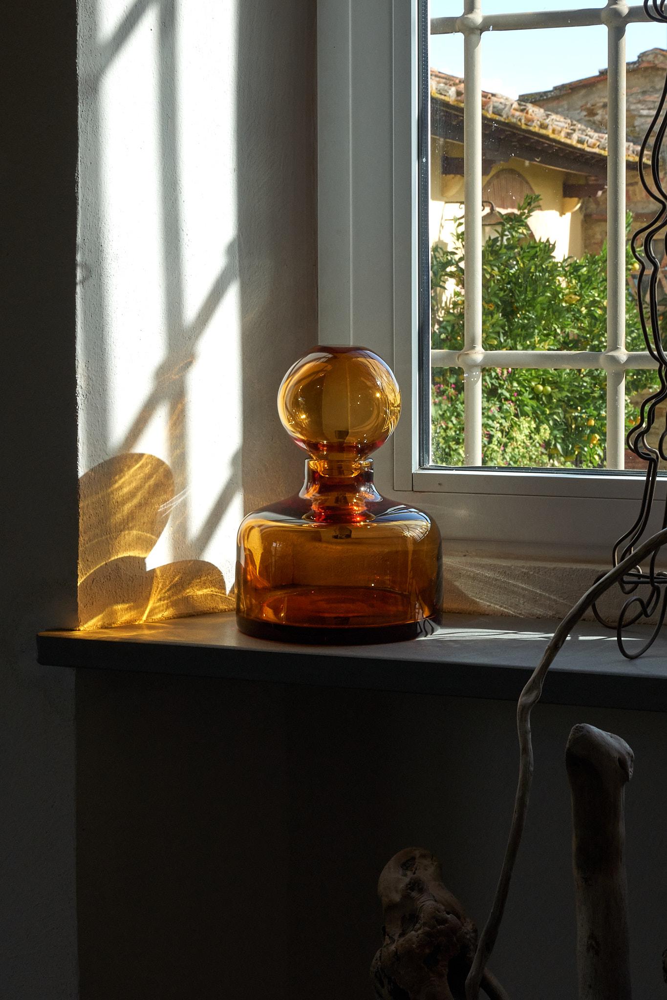 Pure Crystal Cefalù Vase by Studio Bojola
Dimensions: D 21 x H 26 cm
Materials: Pure crystal. Colour: Amber. 
Weight: 3 kg. 

The Cefalù is a combination of two vases, that can serving as both a sculptural crystal piece and a flower vase ensemble.