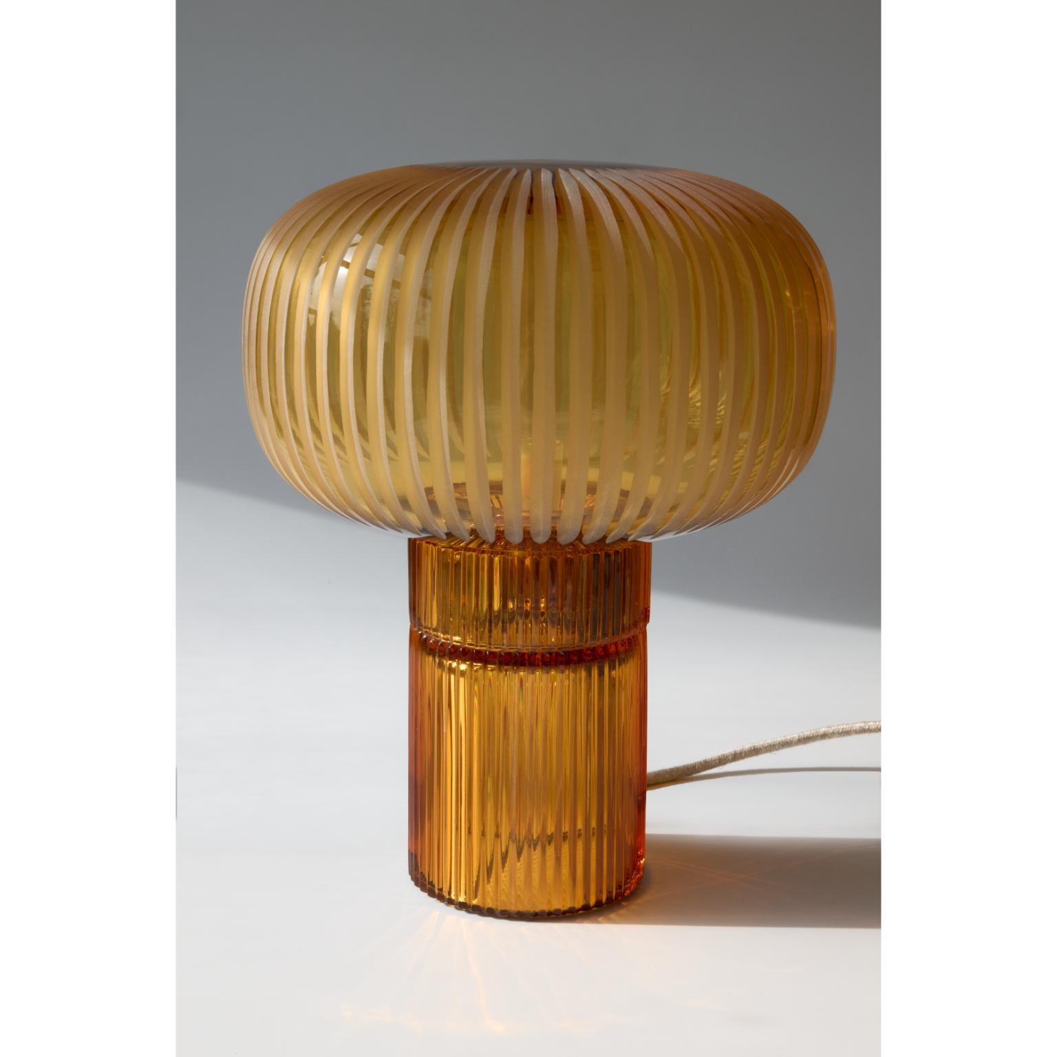 Pure Crystal Glass Onna Clear and Grande Amber Table Lamp by Studio Bojola
Dimensions: D 26 x H 47 cm
Materials: Pure lead crystal glass. Color: Amber.
Weight: 4.5 kg. 

NINA, inspired by the elegance of a small Roman column, the “Colonnina,” is a
