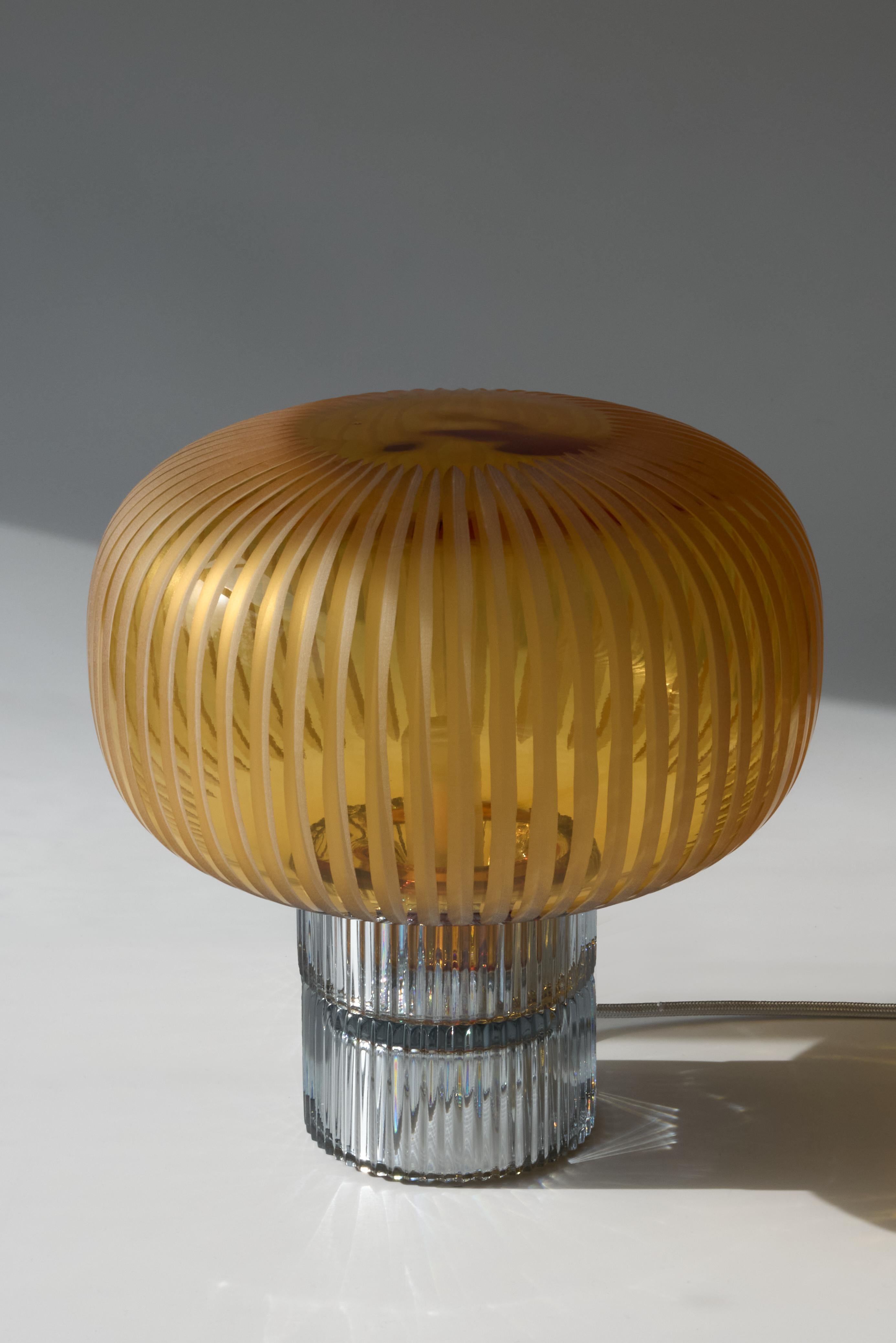 Pure Crystal Glass Tello Grey and Grande Amber Table Lamp by Studio Bojola
Dimensions: D 26 x H 26 cm
Materials: Pure lead crystal glass. Color: grey and amber.
Weight: 3.5 kg. 

TELLO, inspired by the Roman “Capitello,” is a table lamp that