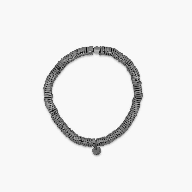Pure Disc Expandable Bracelet in Black Rhodium Plated Silver, Size L

Irregular shaped, hand-polished silver discs sit stacked together to create a harmonious, multi-layered piece. Crafted and carved uniquely by hand in our Imperial Wharf, central