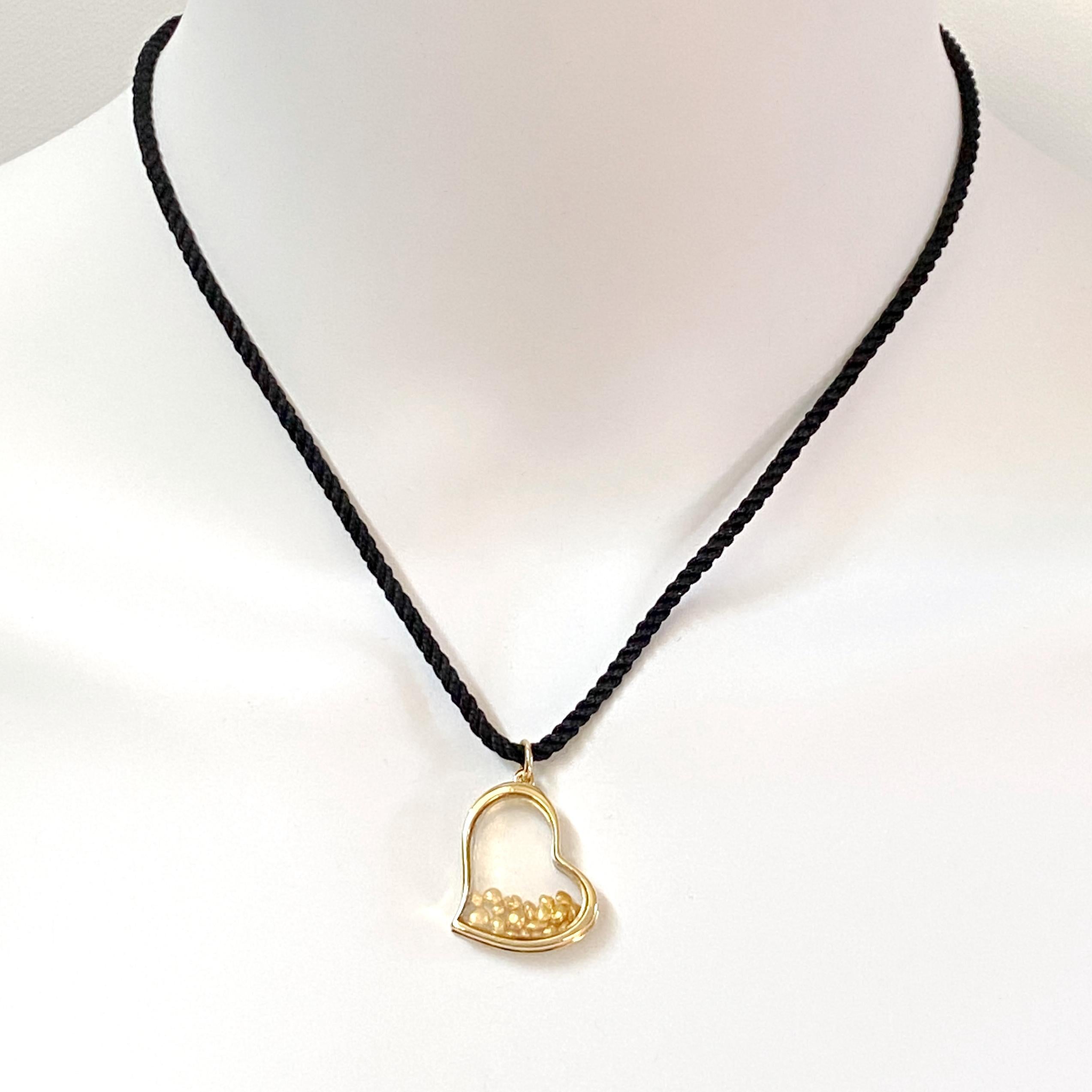 This custom pendant features almost 2 grams of tiny pure gold nuggets moving freely inside a heart-shaped pendant.  Eytan Brandes made exactly two of these -- one with diamonds, for a customer, and this one.  It's a great piece, and it doesn't have