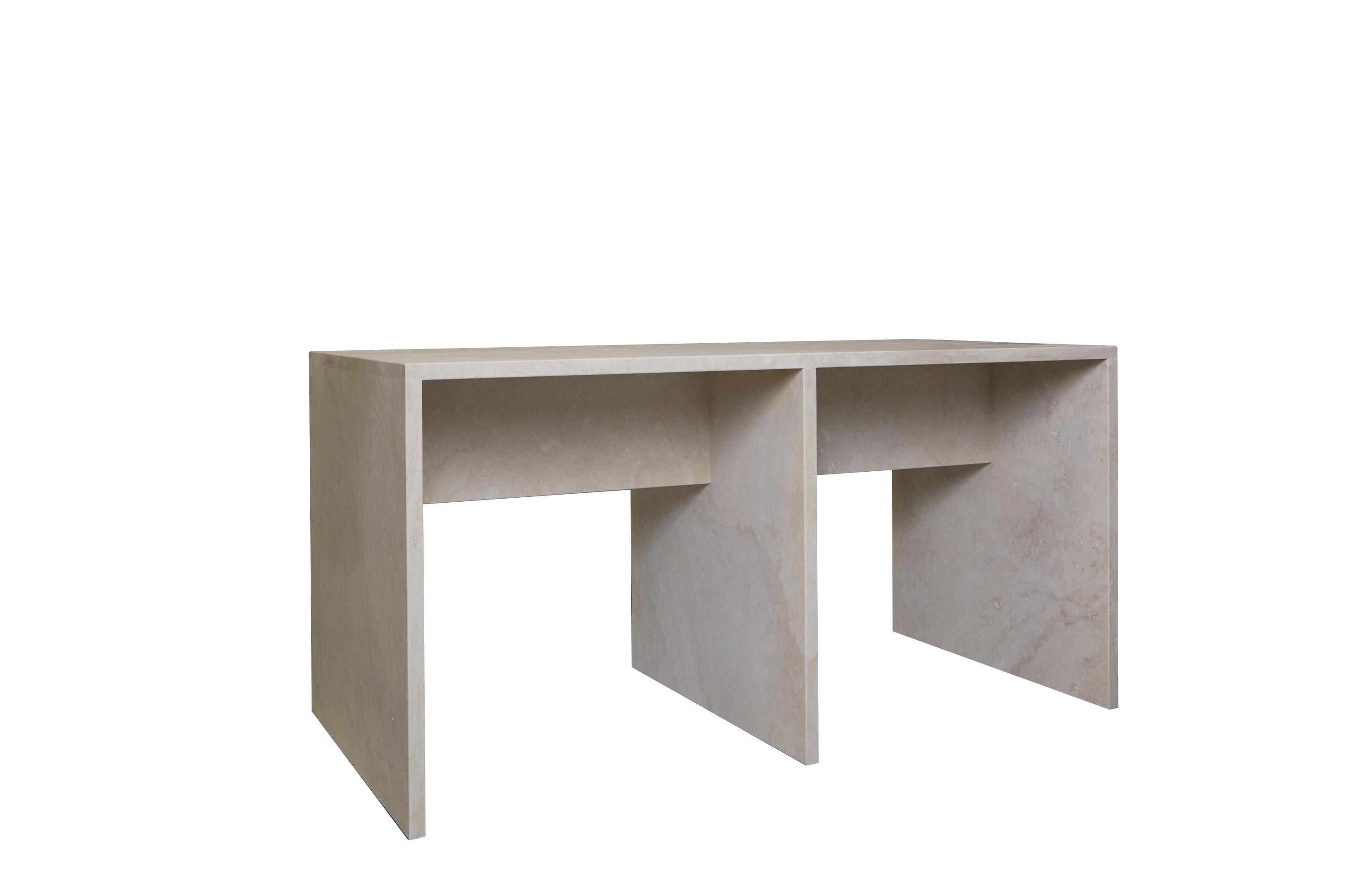 Meticulously and simply crafted with solid travertine slabs, the proportions create a lightness of form juxtaposing the materiality.

A continuation of Coffee Table Nº 106, this console is extruded to desk height with a cross beam for lateral