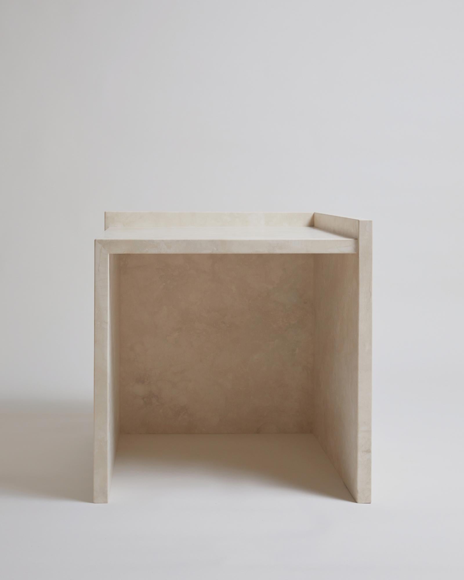 The AA112.2 side table, part of the 'Pure Minimalist' collection by Amee Allsop, is a simple yet architectural design with a focus on the material and form. It is elegantly constructed of 3cm solid ivory travertine that is filled, honed and