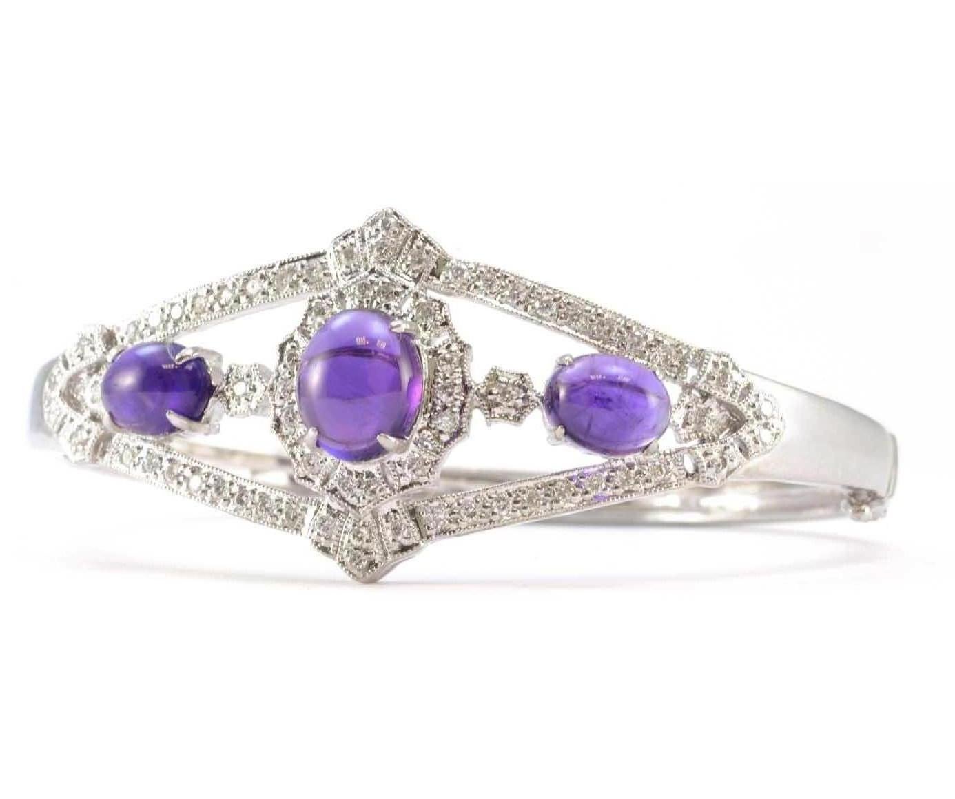 Pure Platinum Genuine Cabochon Amethyst & Natural Diamond Bracelet 37.9g
Excellent condition. This pure platinum bracelet features three cabochon genuine amethyst stones. The center amethyst is oval measuring approximately 11.00mm X 9.04mm. The two