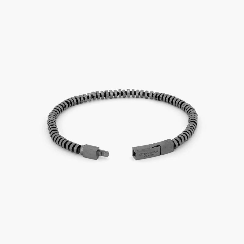 Pure Thread Bracelet with Black Macramé in Black Rhodium Plated Sterling Silver, Size M

Irregular shaped, hand-polished silver discs sit stacked together to create a harmonious, multi-layered piece. Set on black thread, with our classic square