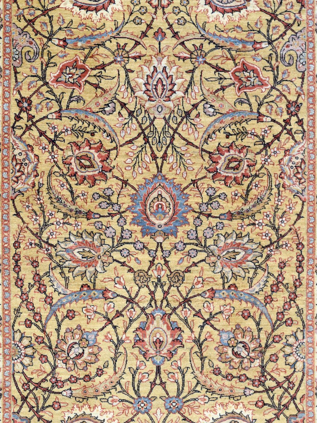 This 5' x 7' pure wool Persian area rug in cream, red, and blue has been handknotted in the Orley Shabahang Mohtasham weave. Measuring exactly 4'7