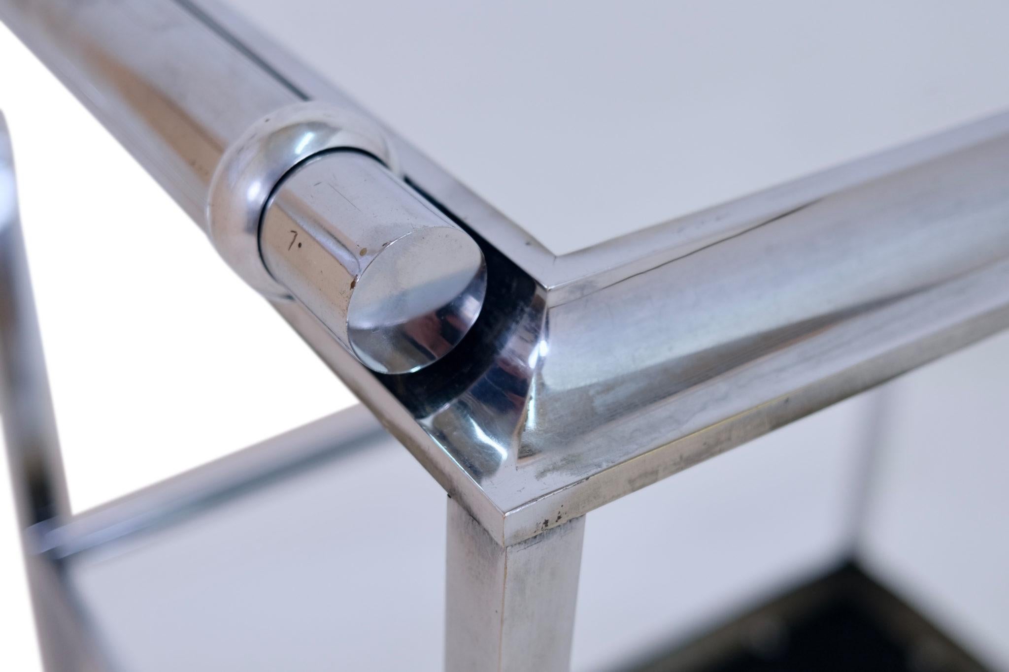 Puristic Art Deco bar cart
An exceptional bar cart from the Art Deco era, made in France around 1930. Made from chrome-plated brass, the design is characterized by clean, geometric lines and a minimalist aesthetic that perfectly reflects the purist