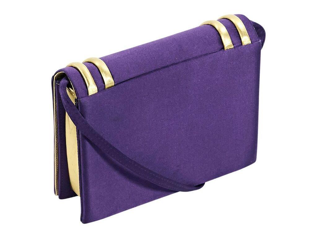 Product details:  Purple satin clutch by Paloma Picasso.  Detachable, tuck-away crossbody strap.  Front flap with concealed magnetic snap closure.  Lined interior with inner slide pocket.  Goldtone hardware.  Dust bag included.  7