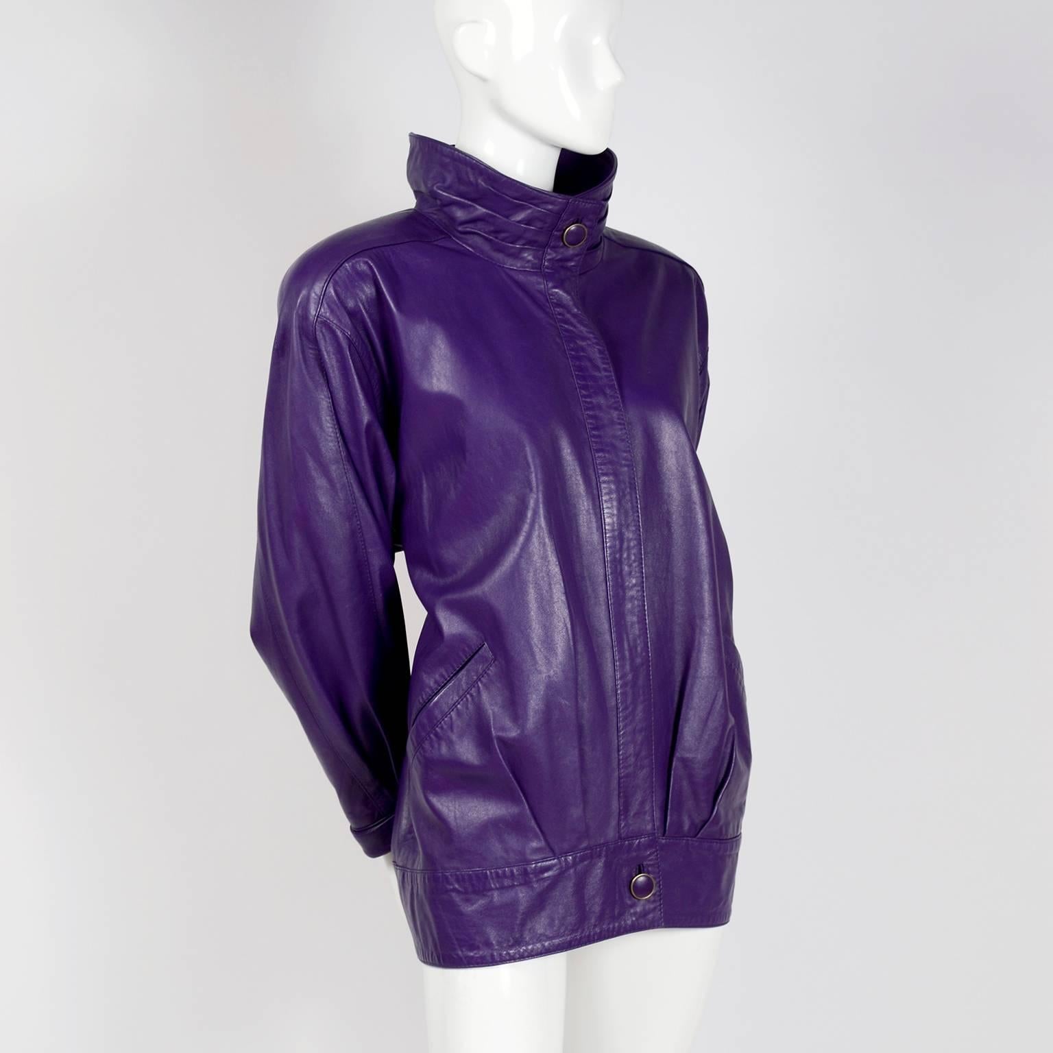 This purple 1980’s leather jacket was made by Melek in the 1980’s. The jacket has slit pockets and is fully lined with a zip front closure and a snap at the bottom and at the neck. Labeled a size Medium, the jacket has that classic 1980’s oversized