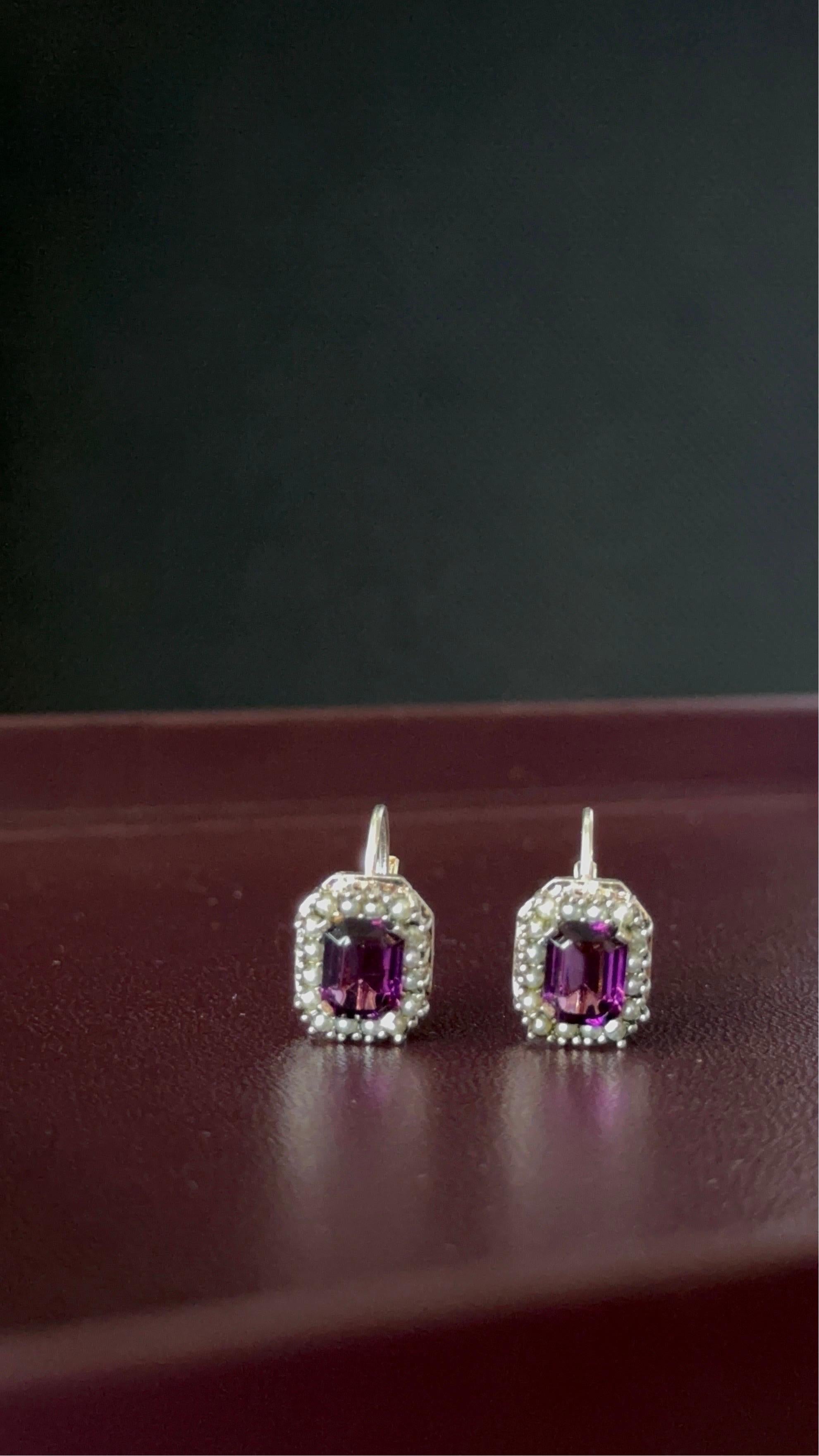Purple Amethyst Earrings in 925 Sterling Silver with Pearl Accents. 

Silver Purity: 925
Total Weight: 4.7g
Stone Measurements: 7.9 mm x 6 mm (x2)