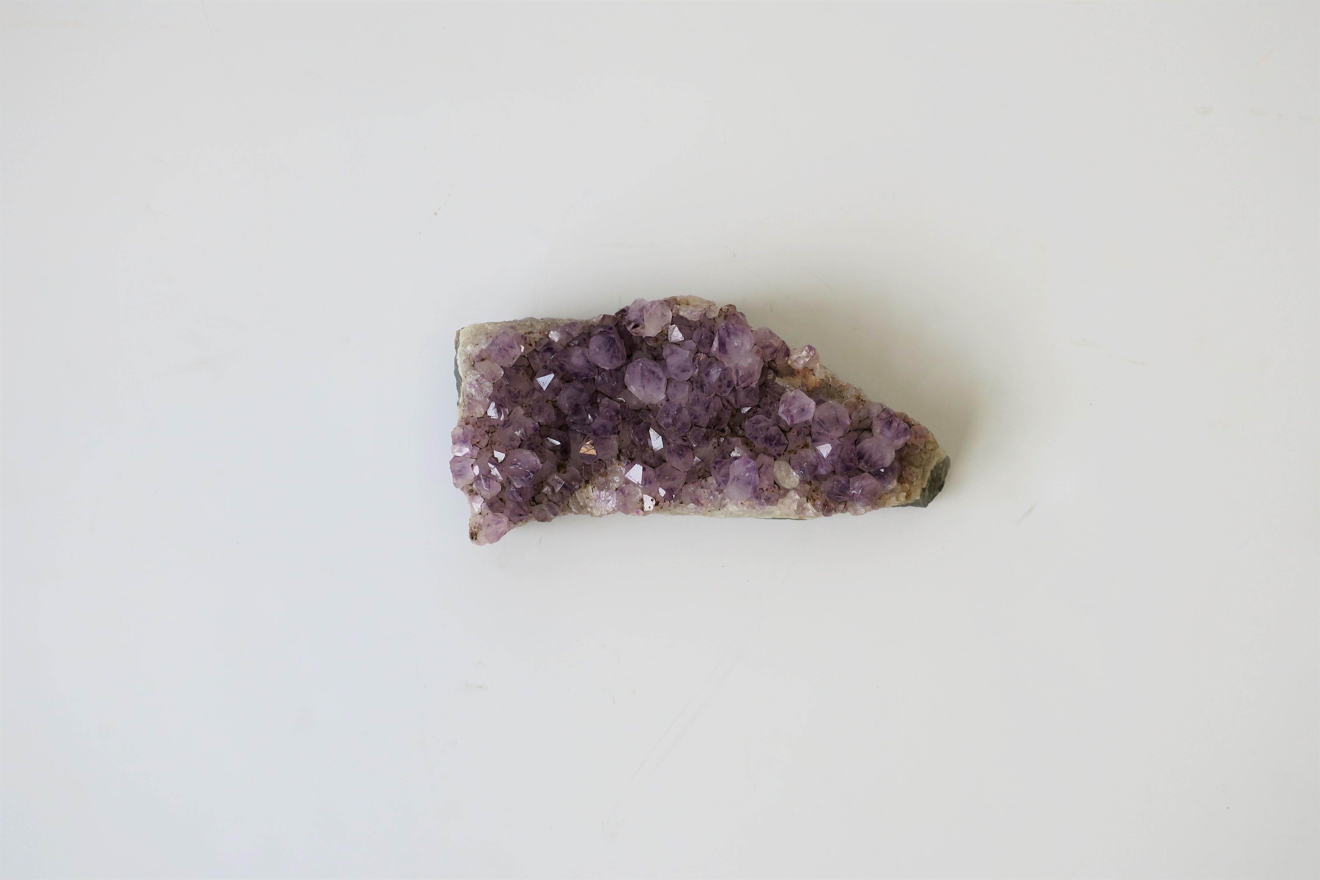 A natural purple amethyst stone piece, circa 20th century. Piece can work as a standalone decorative object, paperweight, or used as a display piece. Measures: 6.25