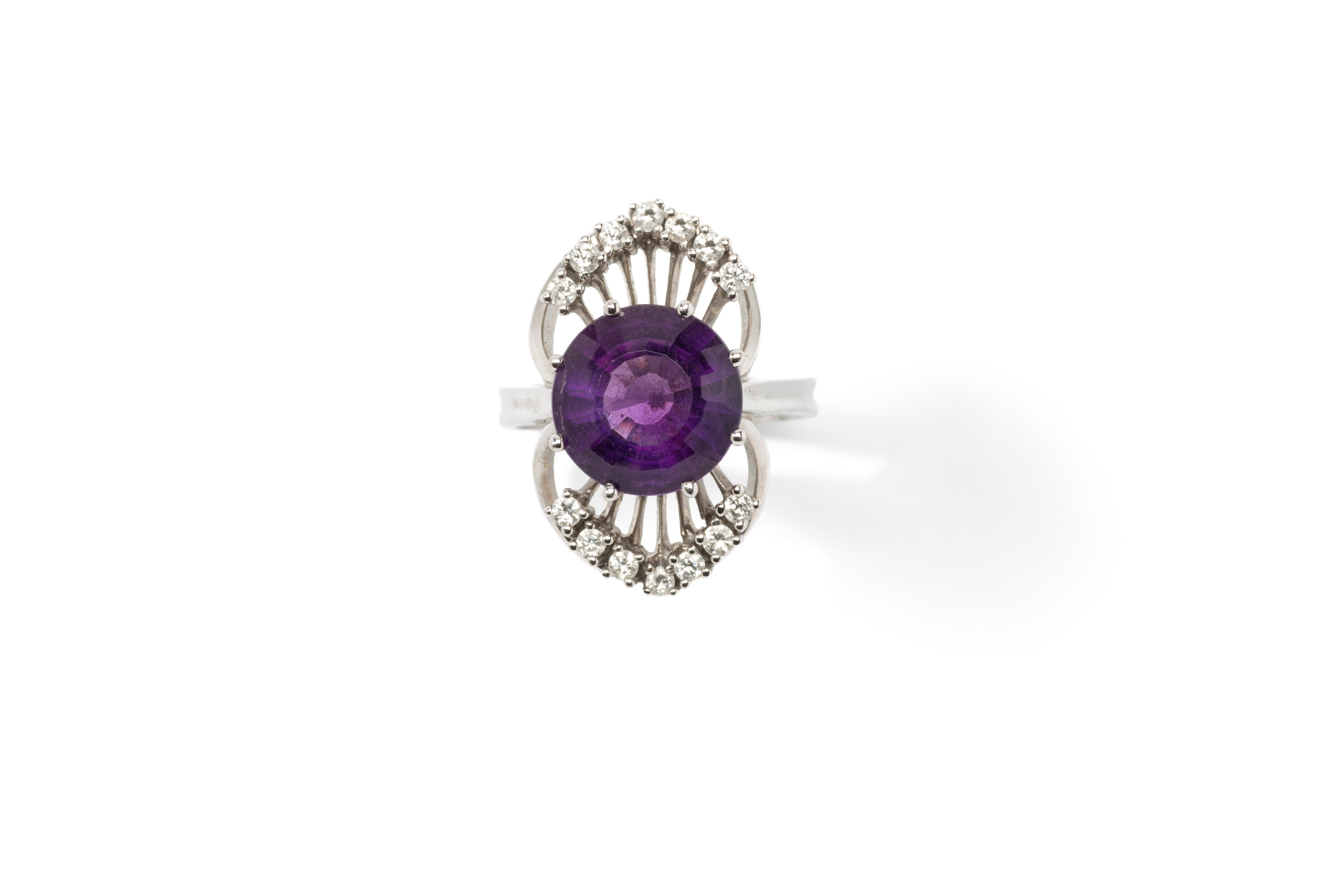 Europe, 1950's. Set with round shaped purple amethyst and 14 brilliant-cut diamonds weighing total circa 0,42 carats. Mounted in 14 K white gold. Hallmarked with 0,42 585 HR. Weight: 13.46 grams. Ring size: 59 ( US 8.5 ). Resizable

