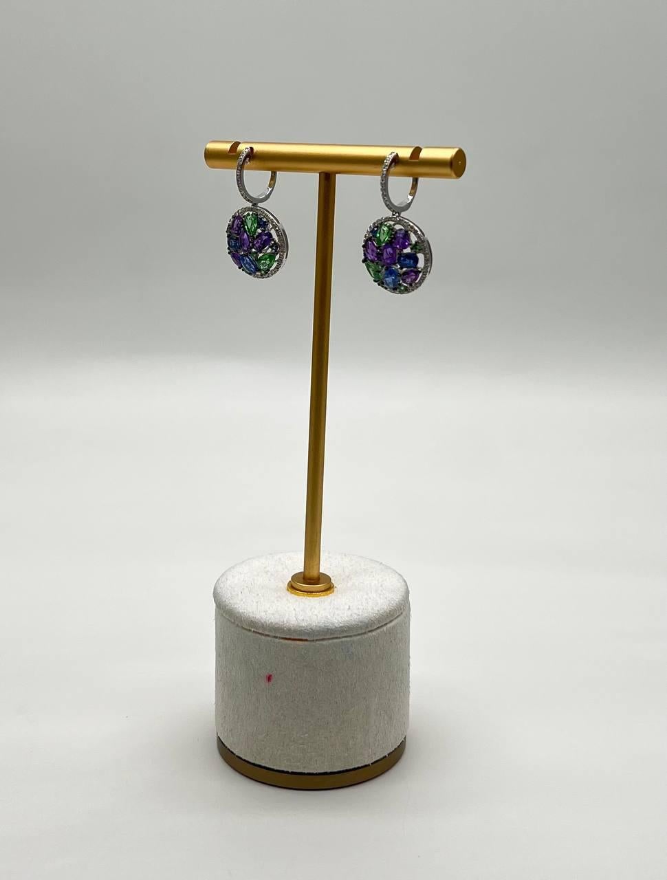 Enhance your elegance with these stunning earrings.
Crafted with vibrant purple and green gemstones, these earrings offer a captivating sparkle, ideal for any special occasion.
Intricate, colorful, and sophisticated.
14K White Gold
0.35 CTW