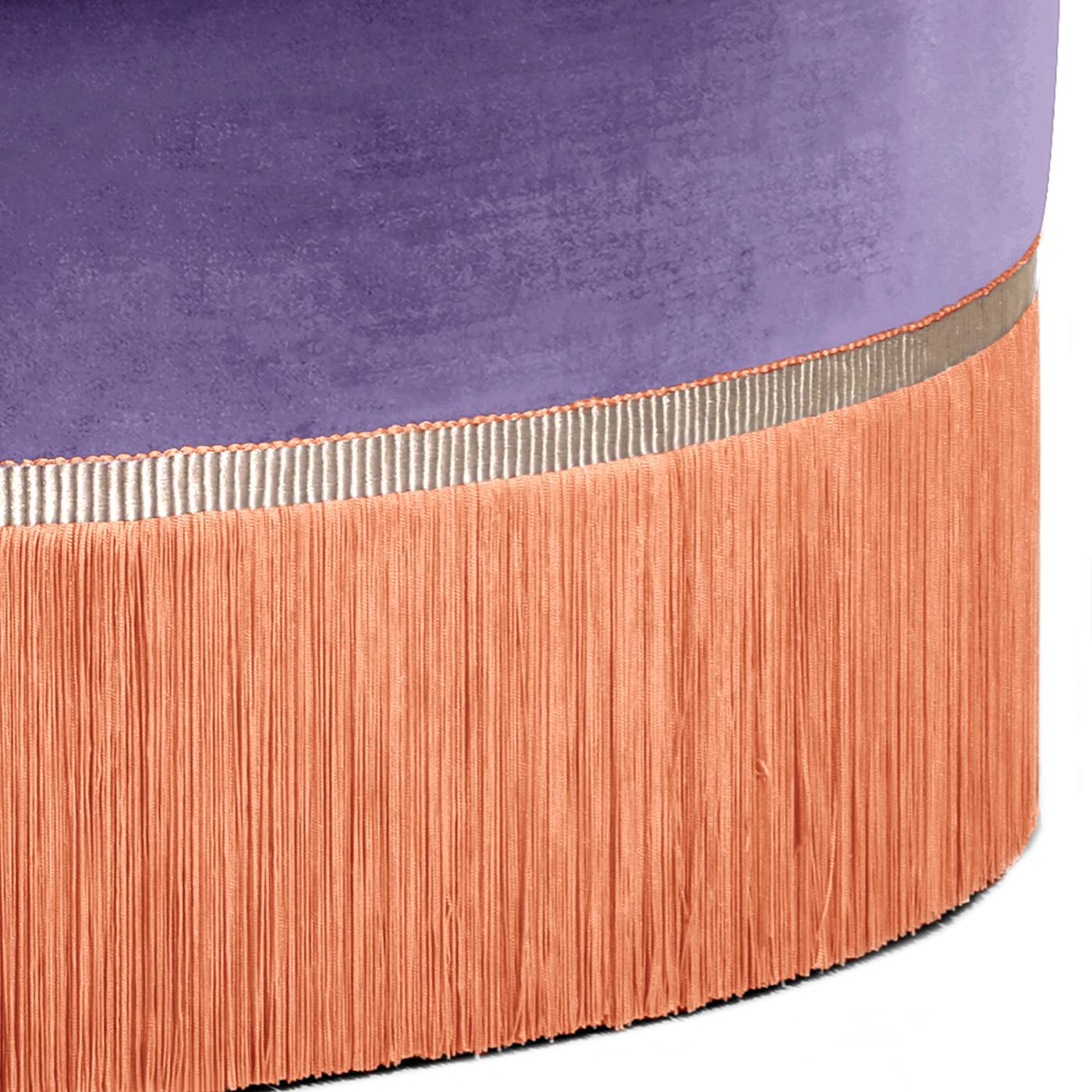 Bold and regal, this pouf from the Couture Geometric Collection doubles as a coffee table. Upholstered in purple velvet 100% trevira and accented with rich orange viscose fringe, the pouf offers rich jewel tones and supple textures. Whether used as