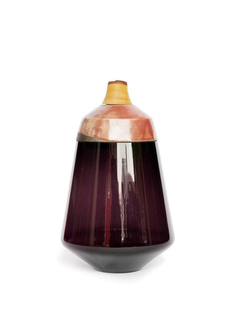 Purple and Rose Ruby stacking vessel, Pia Wüstenberg
Dimensions: D 18 x H 37
Materials: glass, wood, ceramic
Available in other colors.

The Ruby Stacking Vessel, inspired by the reflections on gems, is characterised by the vivid colour of its