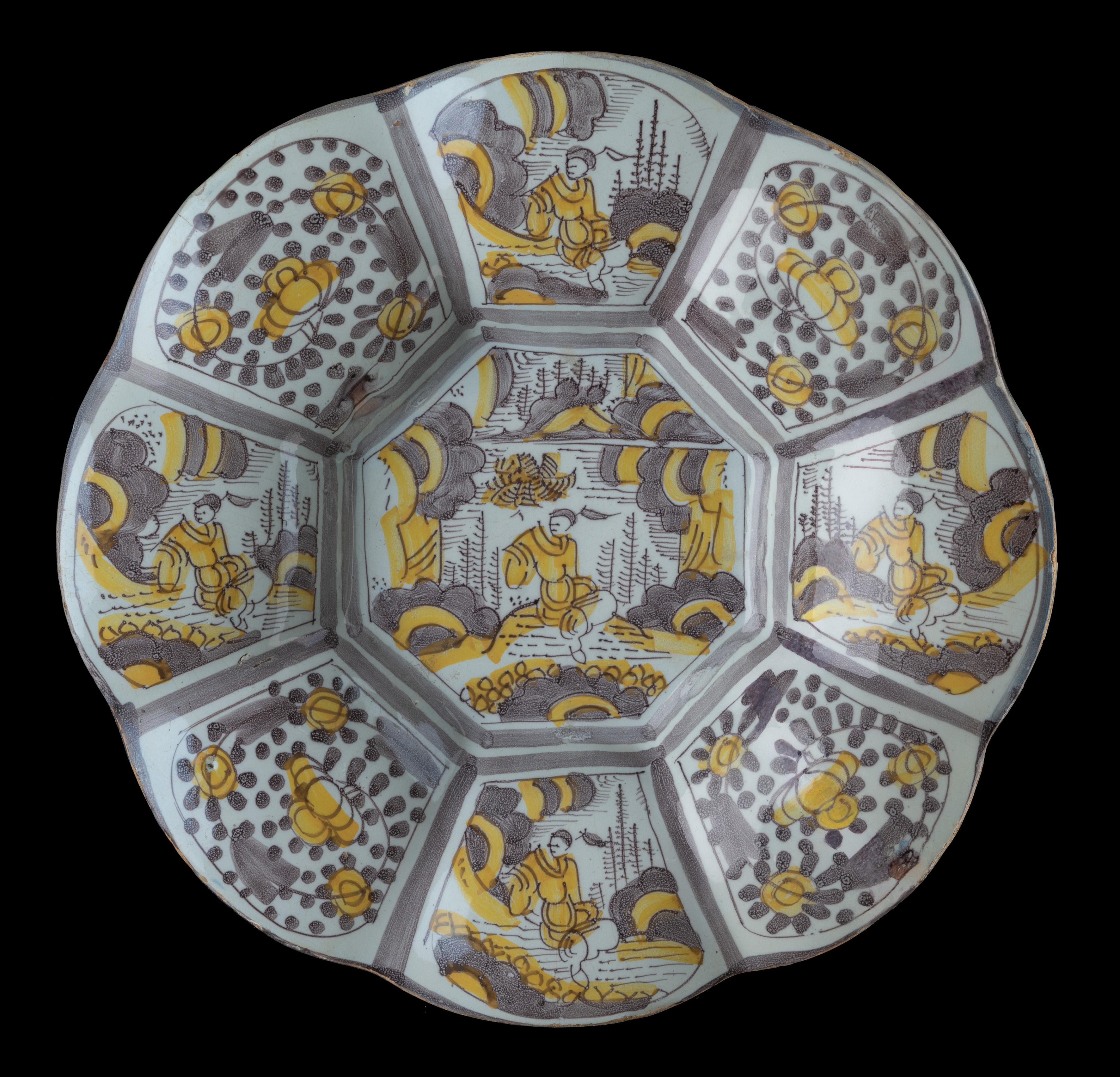 Purple and yellow chinoiserie lobed dish. Delft, 1680-1690 
Dimensions: diameter 34,5 cm / 13.58 in. 

The lobed dish is composed of eight wide lobes and is painted in purple and yellow with a chinoiserie décor. The centre is decorated with a
