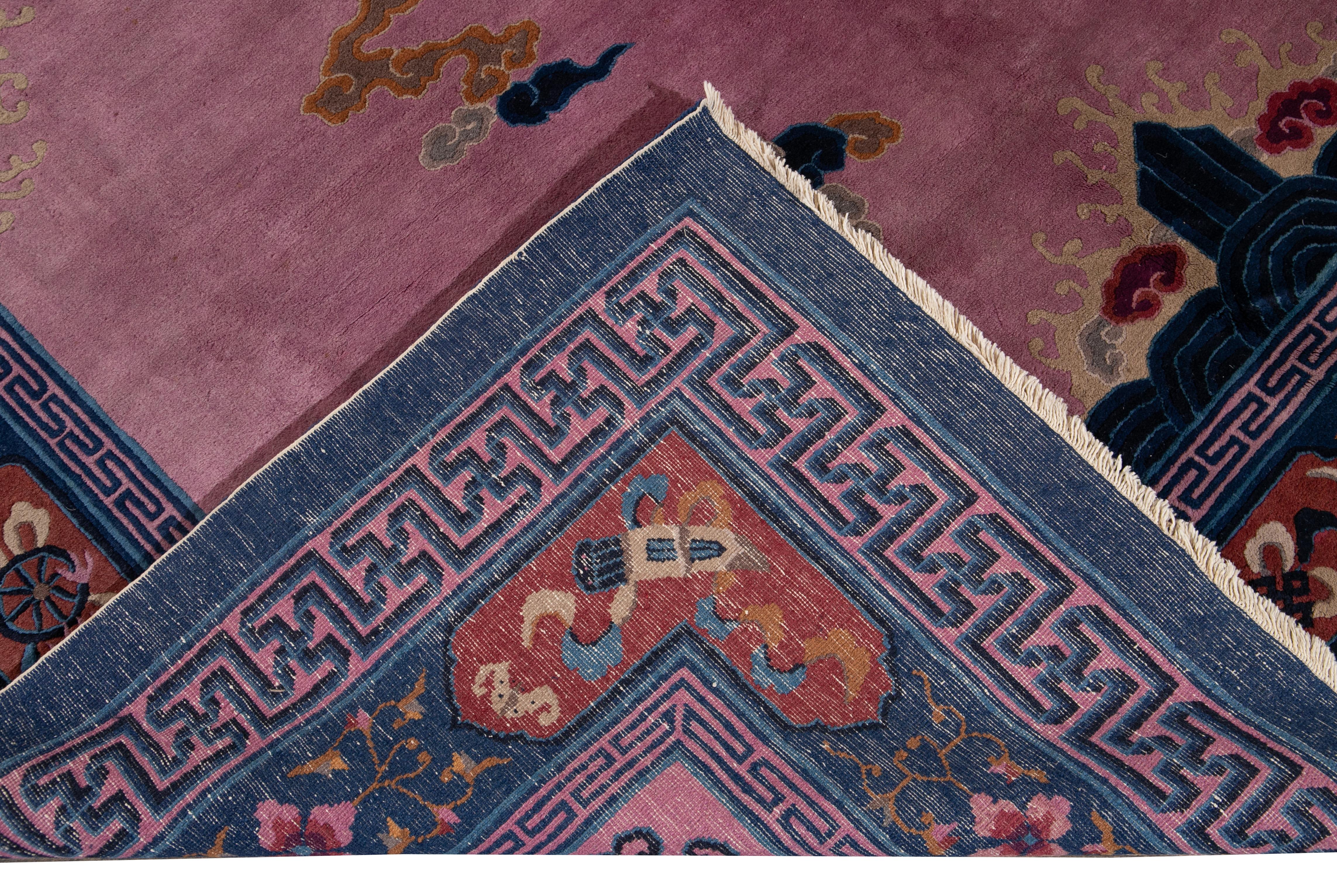 Beautiful unique antique Beijing hand knotted wool rug with a purple field. This Beijing rug has a blue frame and multi-color accents in a gorgeous all-over center dragon Chinese culture design. 

This rug measures: 9'0