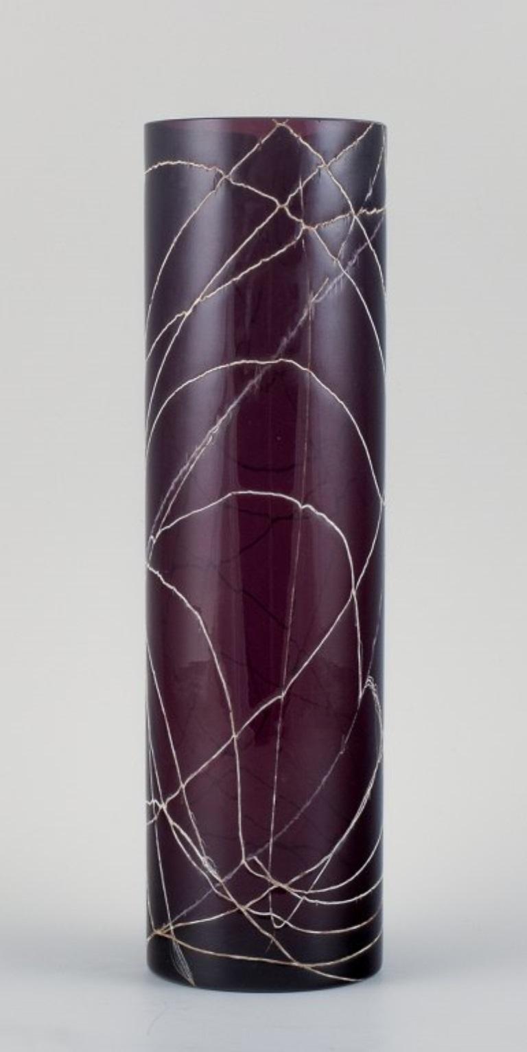 Purple hand-blown art glass vase decorated with silvery threads.
Unknown glass artist.
Mid-20th century.
In perfect condition.
Dimensions: H 28.0 x D 8.0 cm.