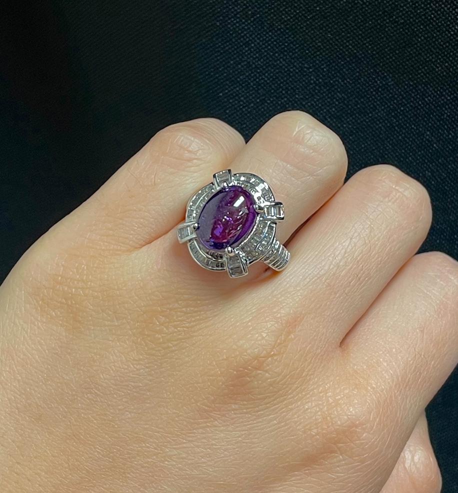 Purple Cabochon Sapphire Ring 

A white gold ring set with a center purple cabochon sapphire accented by baguette-cut diamonds

Approximate Sapphire Weight: 6.90 carats
Approximate Diamond Weight: 1.50 carats
Ring Size: 6
Resizable free of