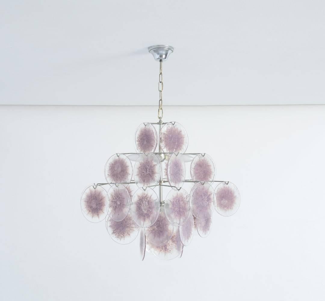 This small purple crystal glass chandelier was made by Vistosi in Italy in the 1960s.
The purple Murano glass discs are hanging on a metal frame in different heights.
This chandelier is in perfect vintage condition.