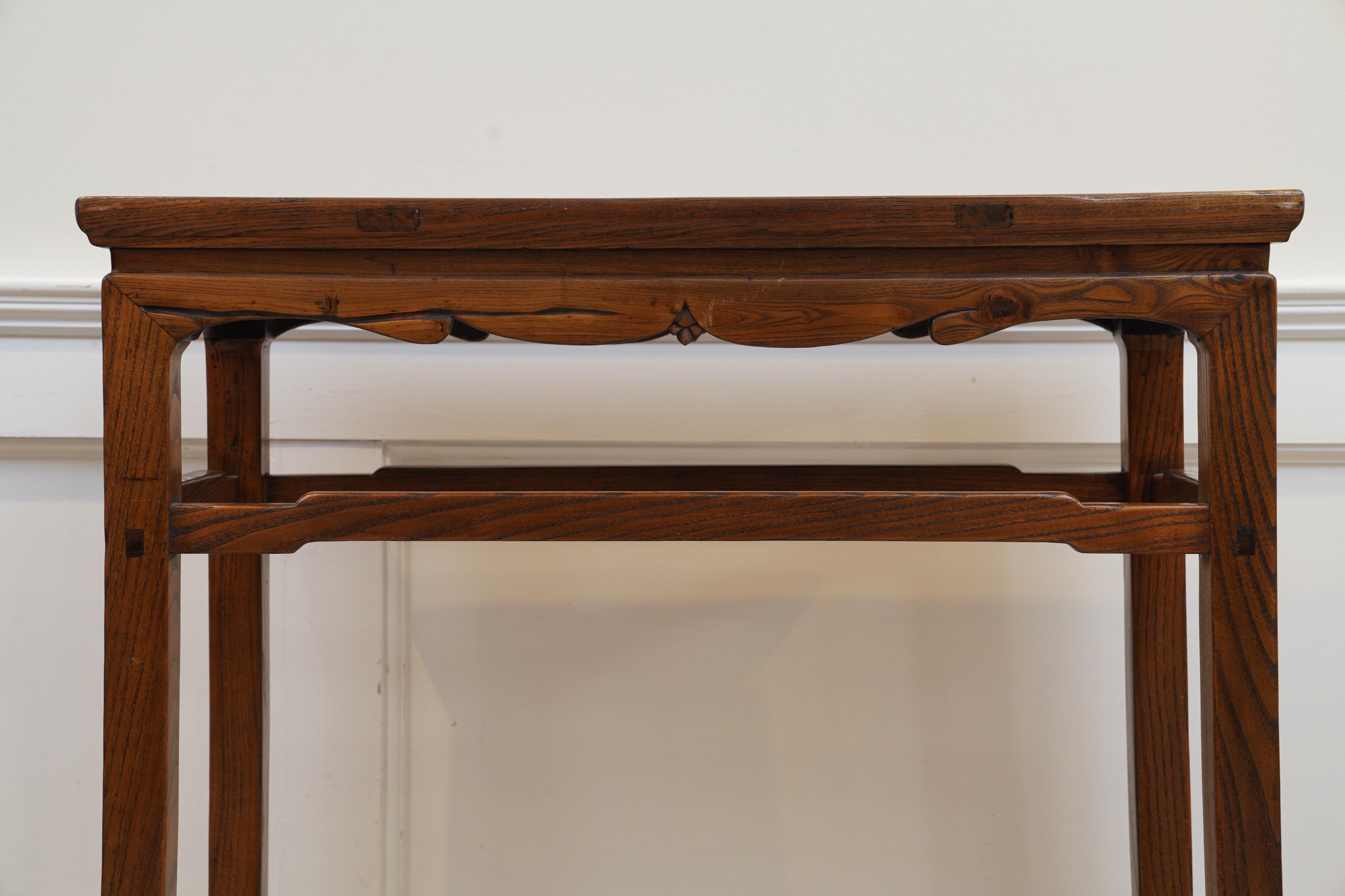 A simple and elegant Chinese table in purple elm with mortise and tenon construction and lovely patina. Originally used a hall or altar table. Great as a console table for an entryway, a server or behind a sofa. C. 1870.