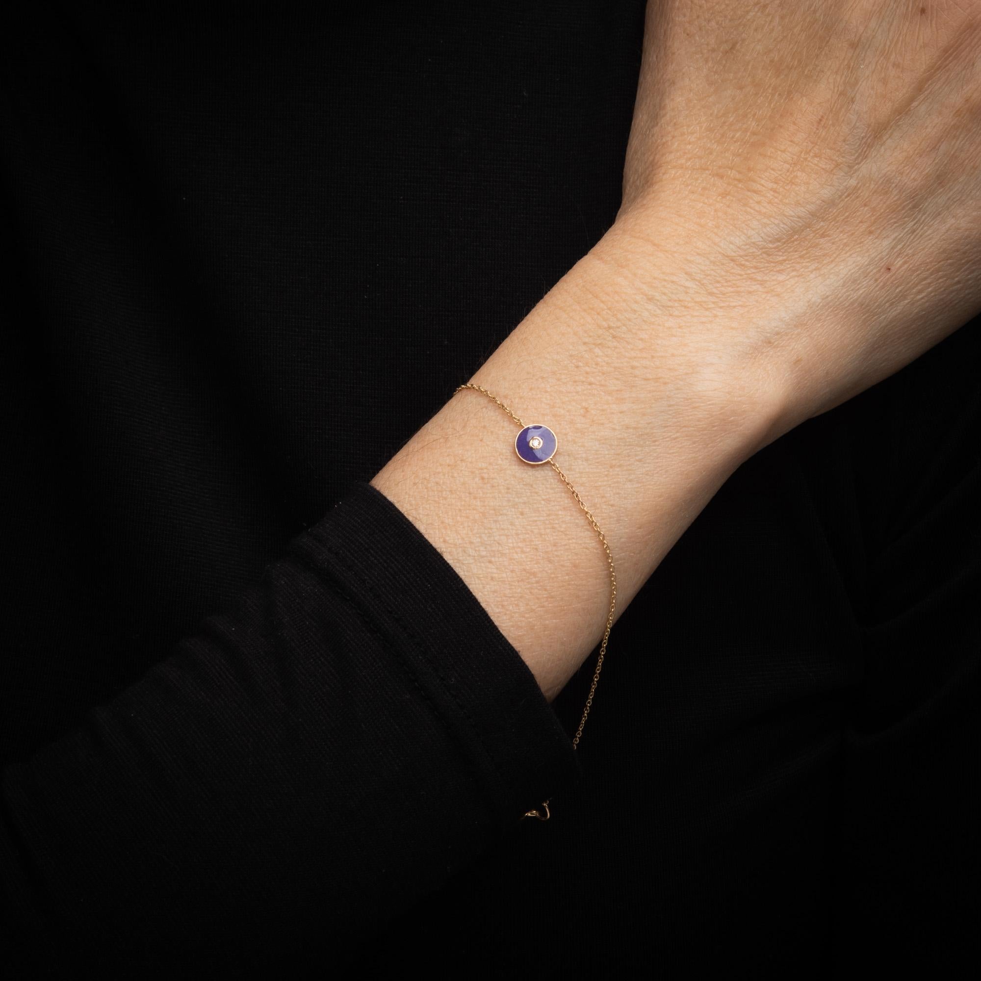 Finely detailed purple enamel & diamond bracelet crafted in 14k yellow gold. 

One estimated 0.02 carat diamond is set into the mount (estimated at H-I color and SI1 clarity).     

The purple enamel is set into a small round disc mount with a small