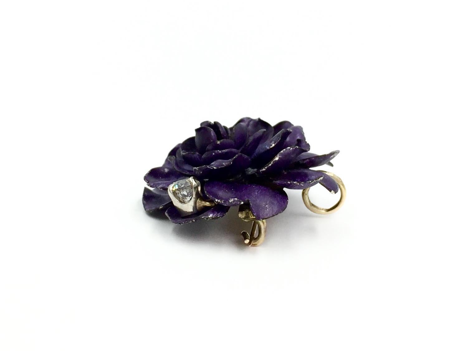 Made of layers of violet enamel petals and 14k yellow gold, this romantic vintage brooch can also be worn as a pendant. Purple flower features one dangling prong set old mine cut diamond, weighing approximately .30 carats. Diamond is approximately H