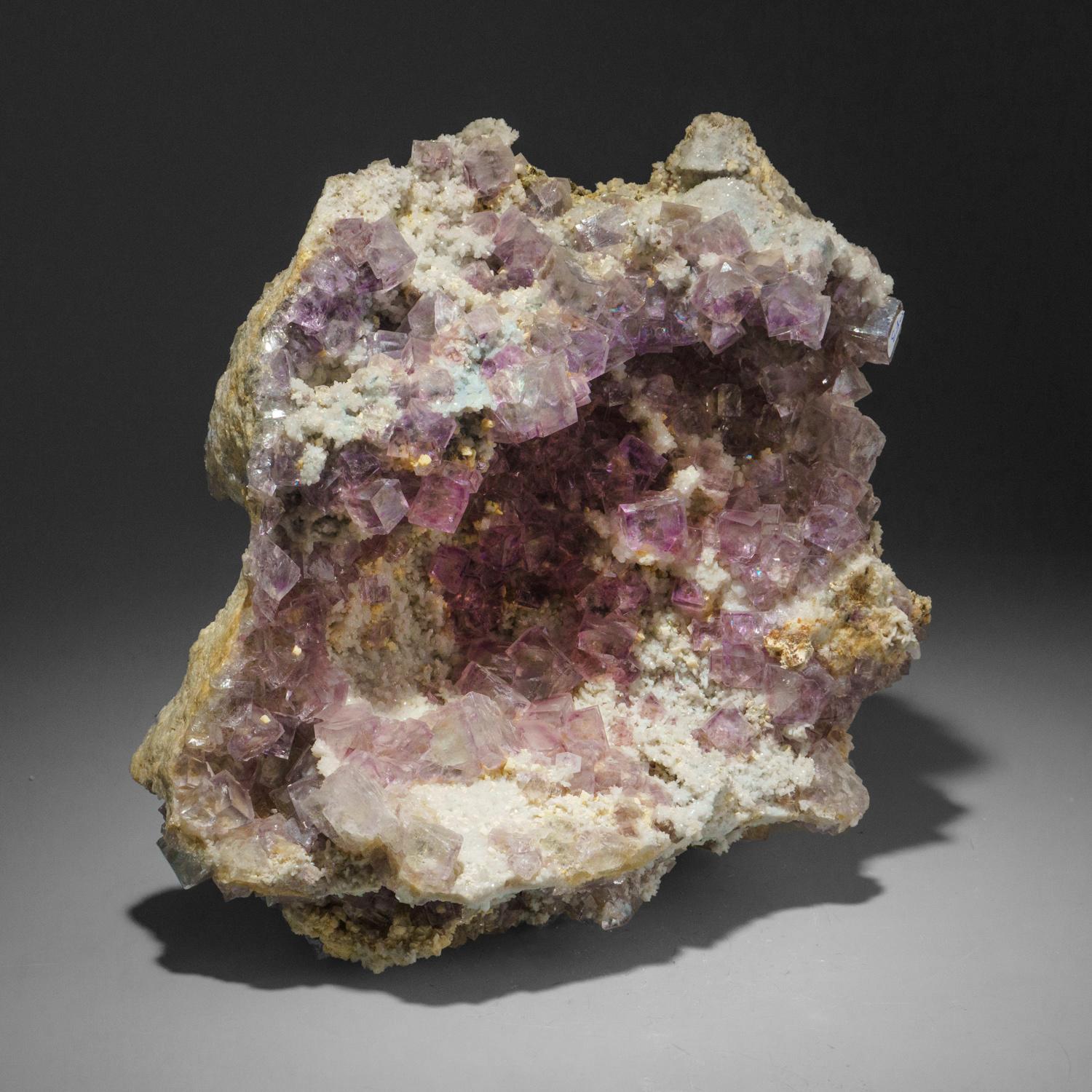From Minggang Mine, Henan Province, China

Large well defined cubic formation of fluorite crystals with crystal faces composed of smaller sub-parallel cubic faces. The fluorite has a pale yellow core with purple zoning. This fluorite is grown