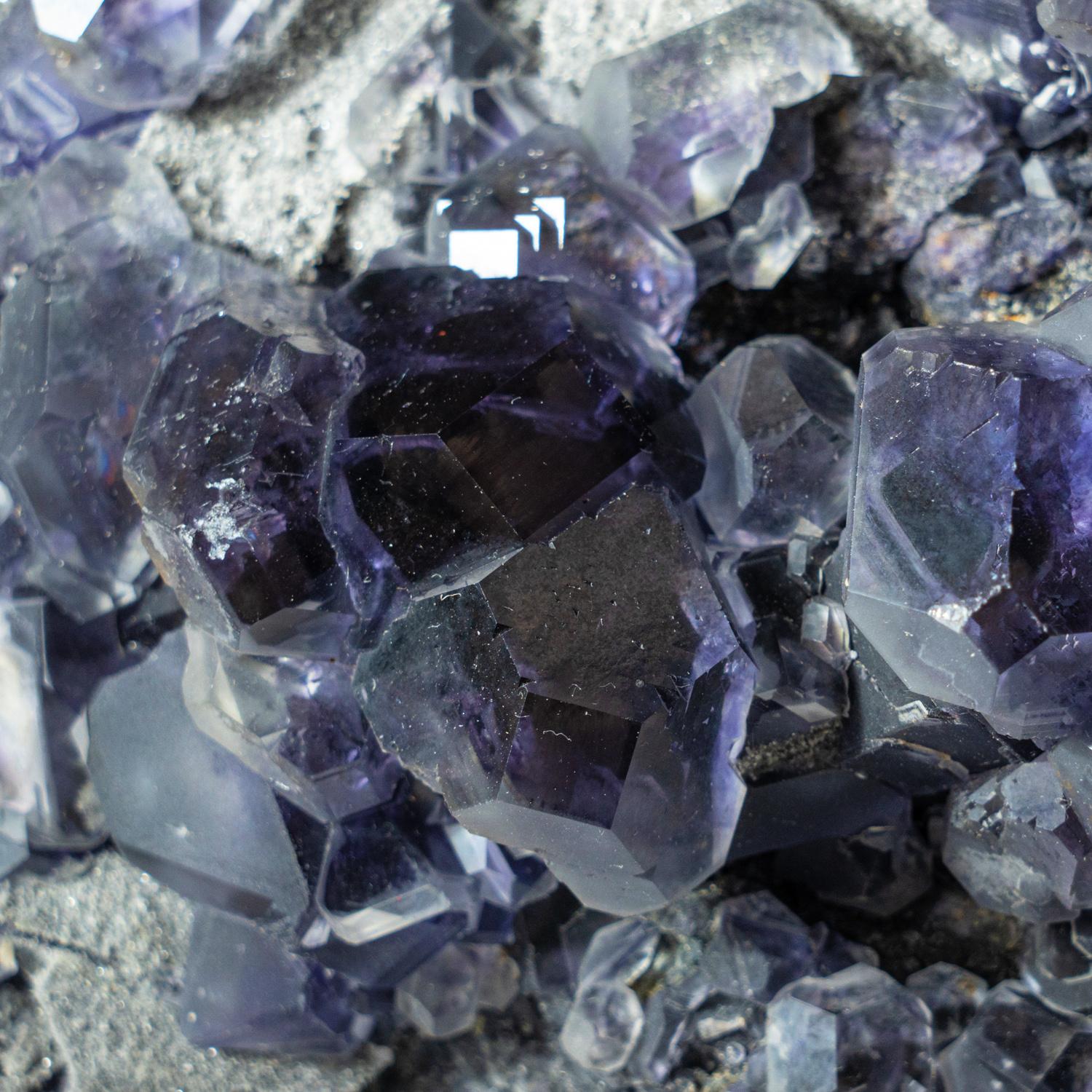 From Minggang Mine, Henan Province, China Translucent cubic purple fluorite crystals overgrown on a bed of metallic luster sphalerite crystals on matrix. The fluorite has rich purple zoning outlining the crystal faces. The combination creates a