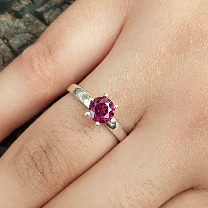 Purple Garnet Solitaire Ring Sterling Silver Ring For Wedding Birthday Gift.
Style
Solitaire
Secondary Stone
Purple Garnet
Main Stone Color
Purple
Ring Shape
Round
Metal Purity
925 parts per 1000
Main Stone
Rhodolite Garnet
Metal
Sterling