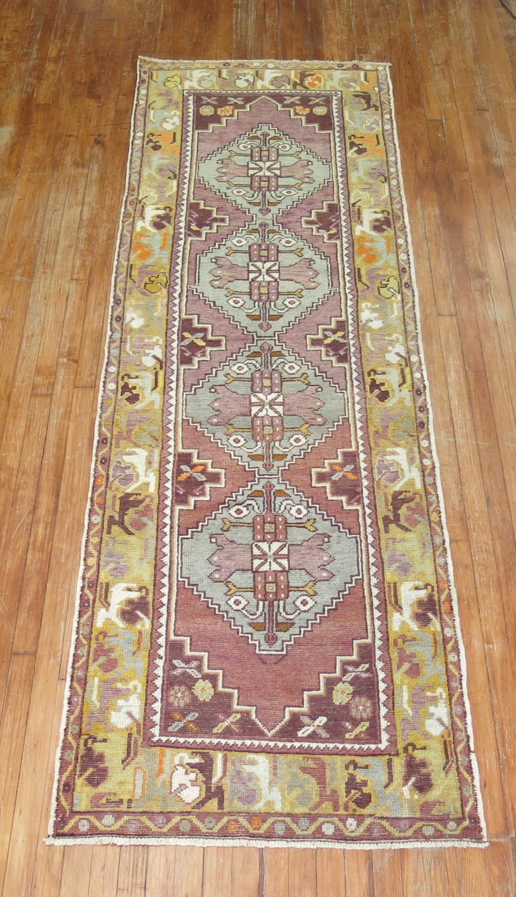Mid-20th century wool Turkish runner with a geometric design on a purple field. The 4 medallions are gray

Measures: 3'x 9'8