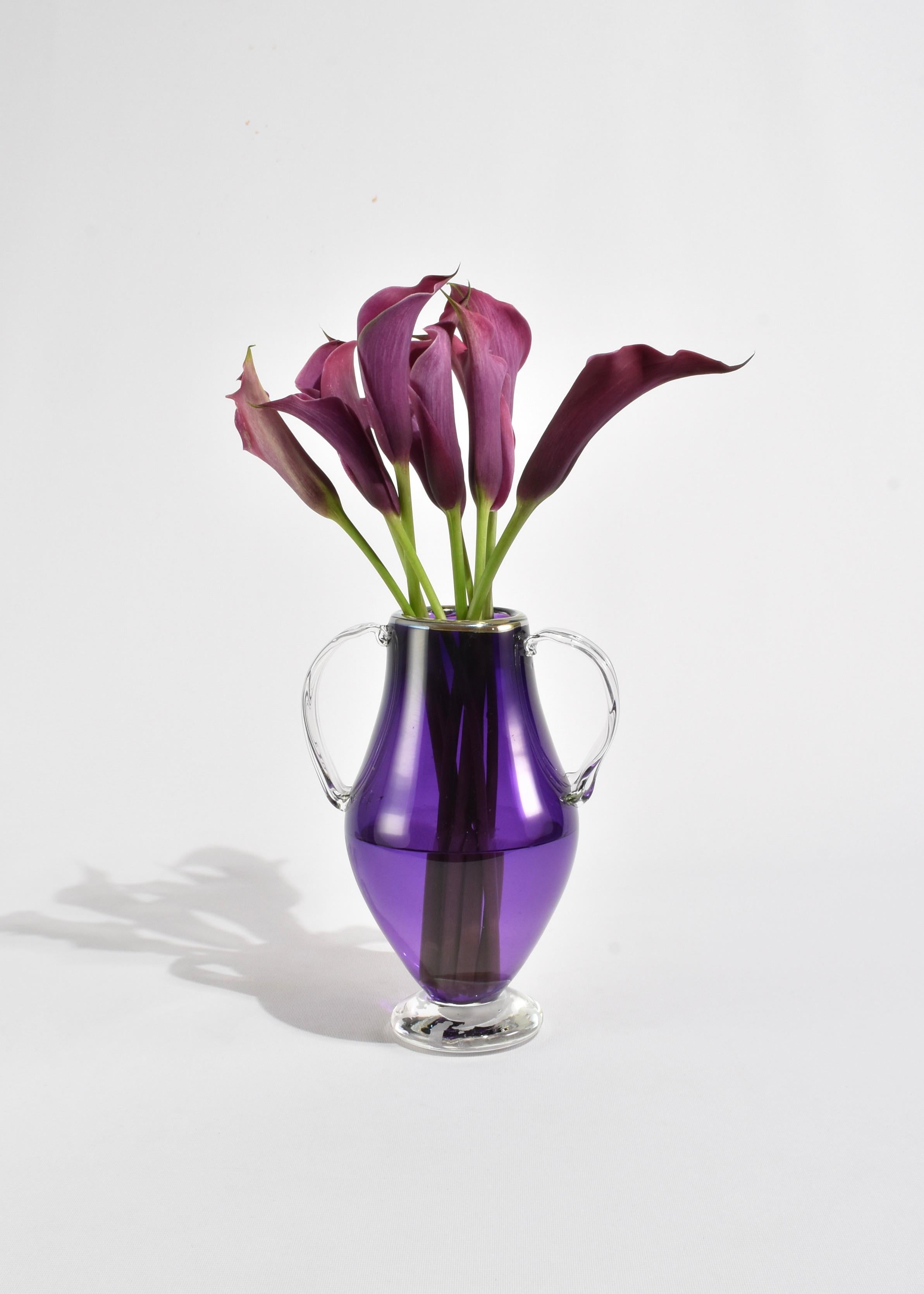 Beautiful blown glass amphora vase in purple with clear handles and iridescent rim.