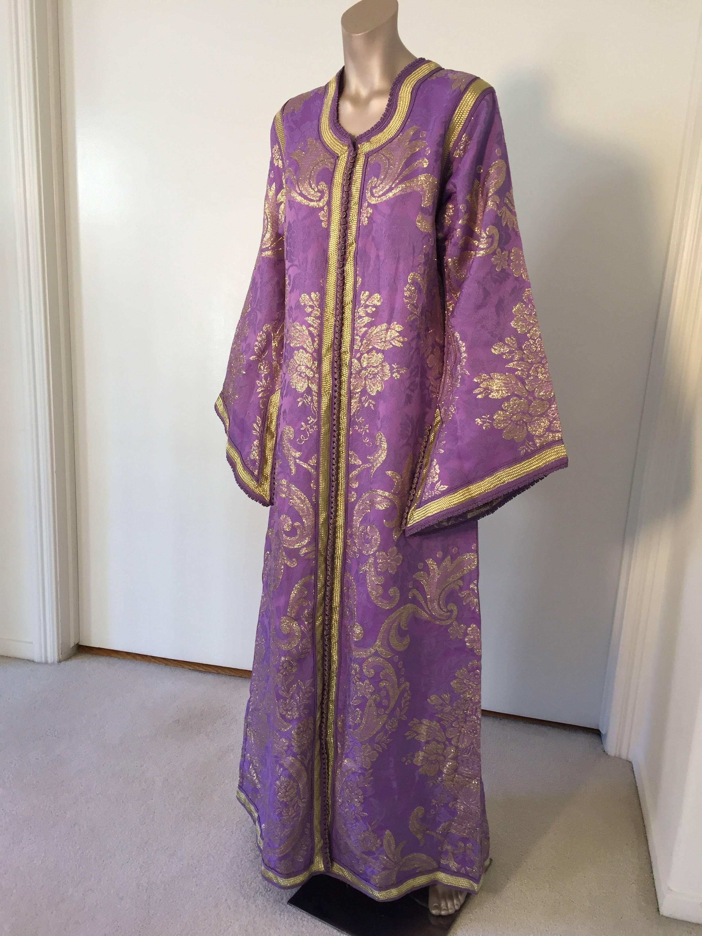Evening or interior lavender and gold metallic floral brocade dress kaftan with gold trim.
Hand-made ceremonial caftan from North Africa, Morocco.
Vintage exotic 1970s metallic purple brocade caftan gown.
The luminous lavender and gold metallic