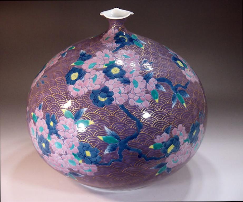 Exquisite contemporary Japanese decorative porcelain vase, intricately gilded and hand painted in  shades of puple, blue and pink on an ovoid shape body with an attractive scalloped rim, a signed piece by highly acclaimed master porcelain artist