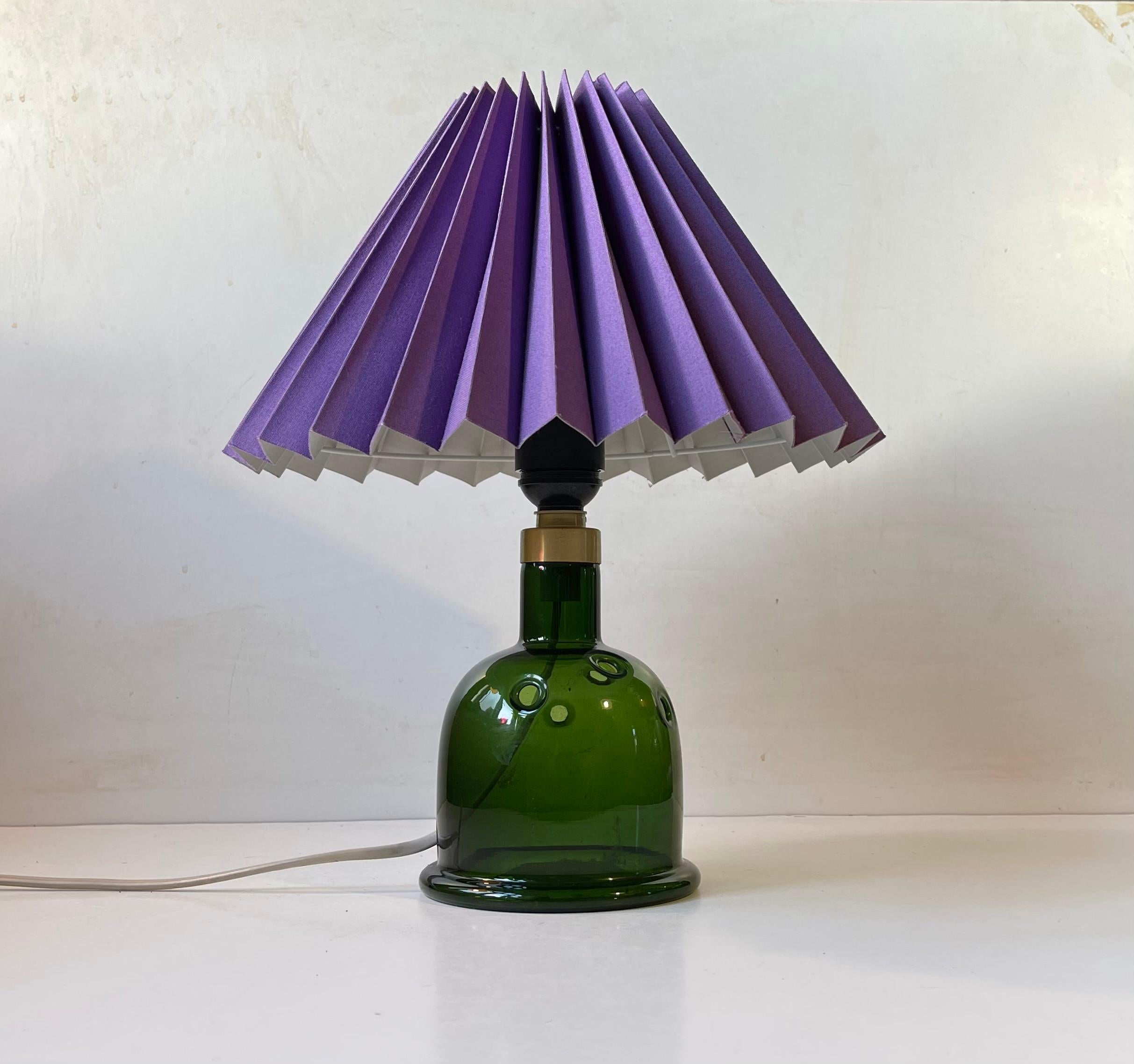 Handblown deep green Glass Table Lamp designed by Michael Bang and manufactured by Holmegaard in Denmark during the late 1970. It is called Meteor. Label from Holmegaard still present beneath the base. Height with shade 35 cm. It comes mounted with