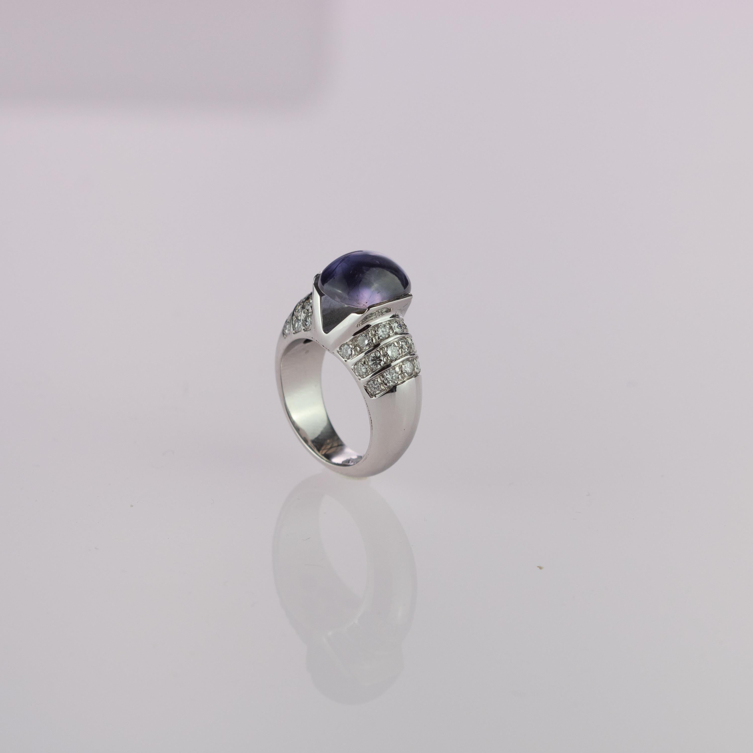 Admire a splendid and unique ring full of beauty and uniqueness. A 13 carat translucent light purple Iolite gem that melts inside of 18 karat white gold with 0.96 carat diamonds full of elegance and style. 
 
This ring is inspired by the beauty of