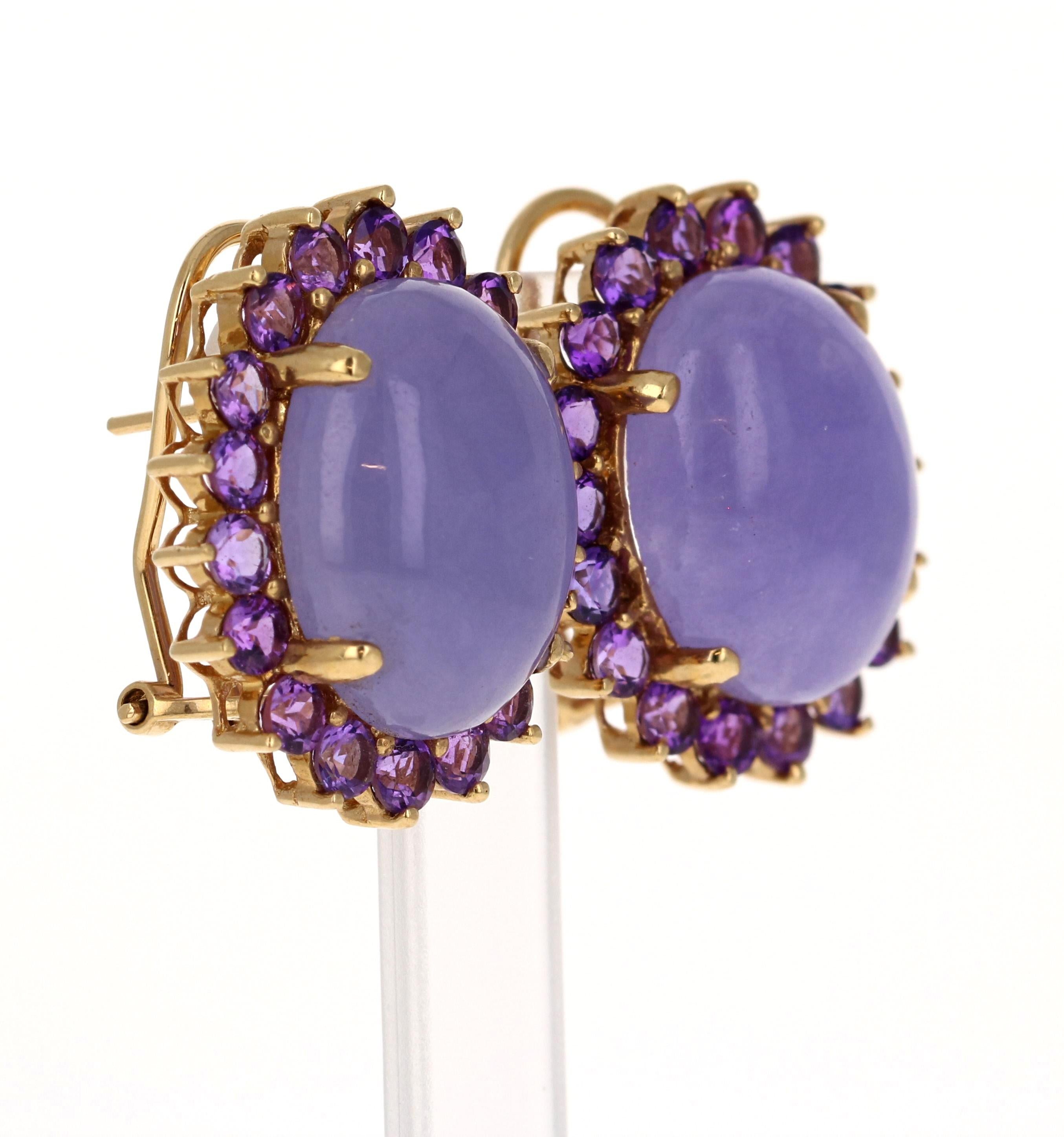 These cluster earrings feature cabochon-cut purple jade as the primary stone. The purple has been dyed as per industry standards of jade. Surrounding the jade are round-cut amethysts with a total carat weight of 3.25, all in a rich purple hue.