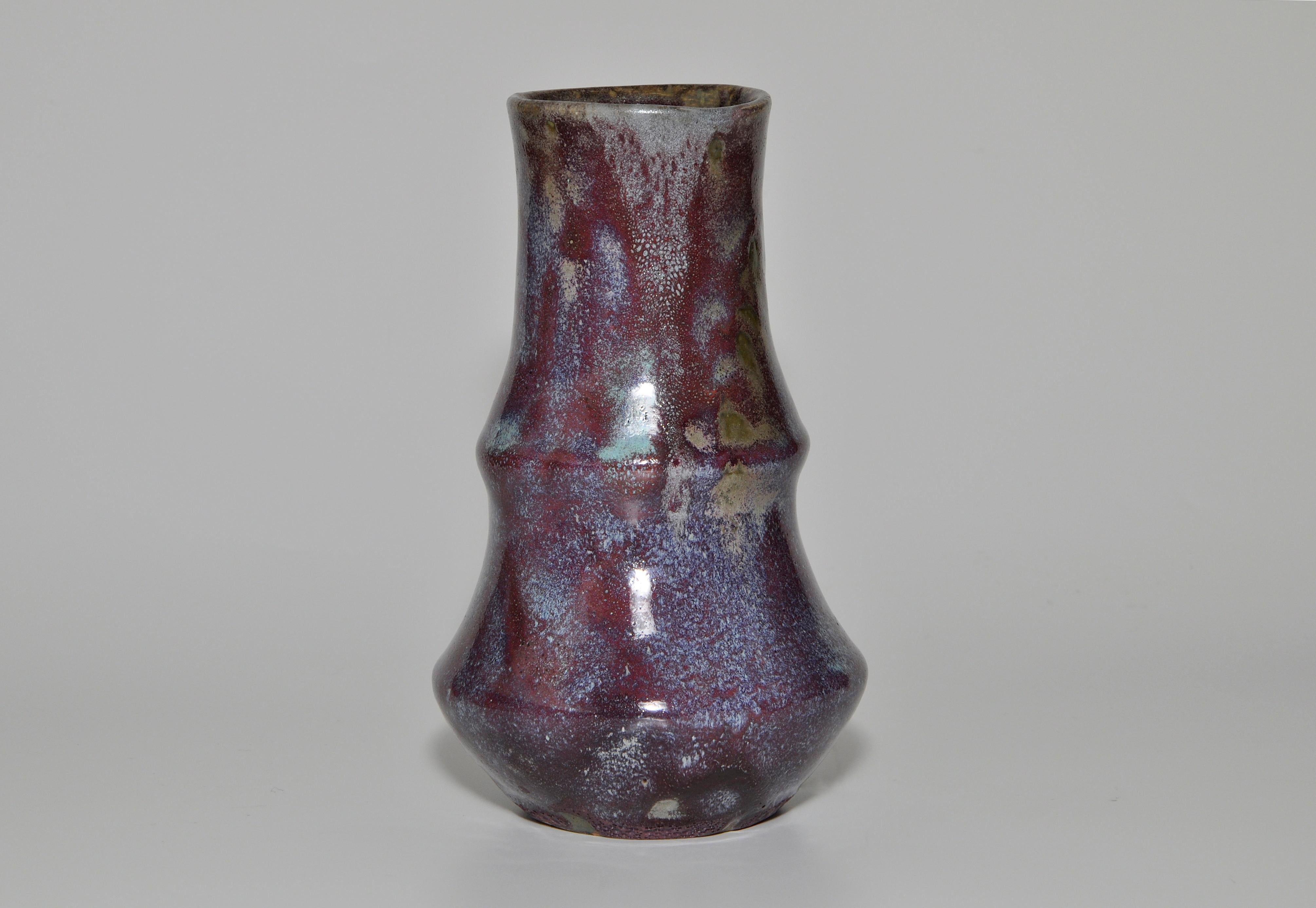 Purple Japonist Art Pottery by Eugene lion vase 

A perfect piece of Japonist ceramic art. By French art potter Eugene Lion, in a very interesting and unusual shape in stoneware, glossy mottled purple hues with subtle speckled mix of shades.