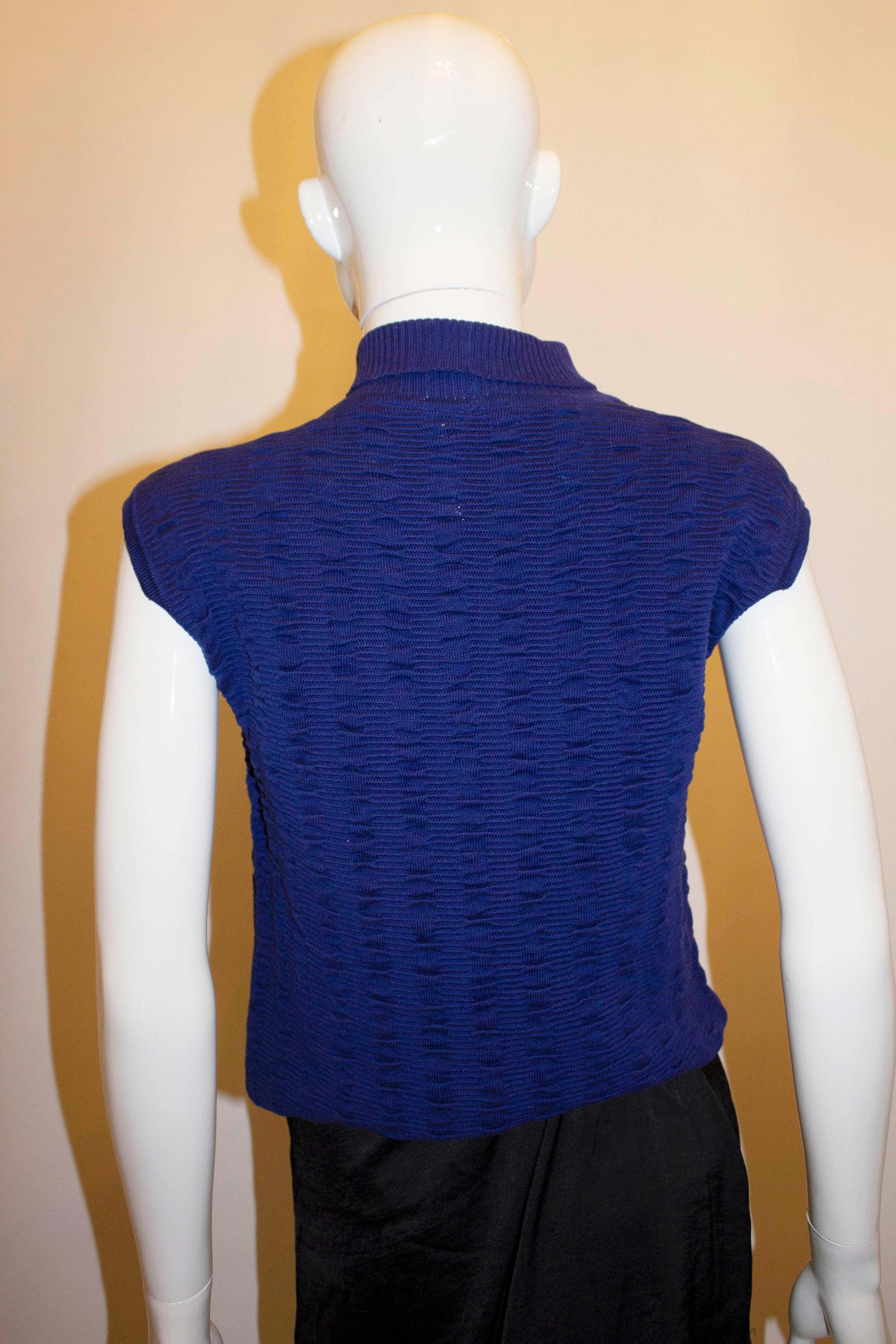 A chic knitted top by Italian firm Filo Scozia. The top has an interesting knit with a  turtle kneck line  and ribbed detail. Measurements: Bust 37'', length 20''