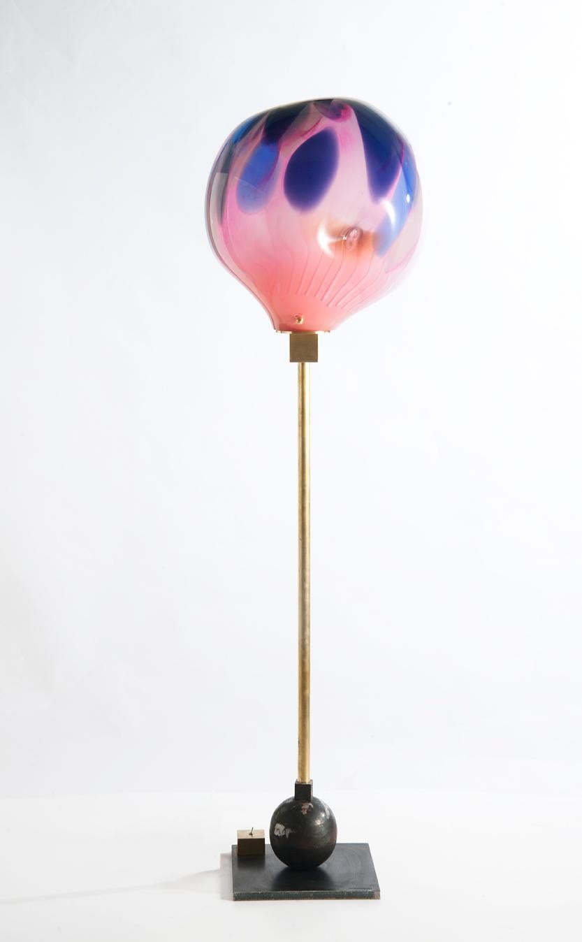 Purple lamp by Sema Topaloglu
Dimensions: 30 x 38 x 138 cm
Materials: base in iron, structure in brass and shade in handblown glass

Sema Topaloglu is known for her dedication to materials, craftsmanship and a unique aesthetic vision. The