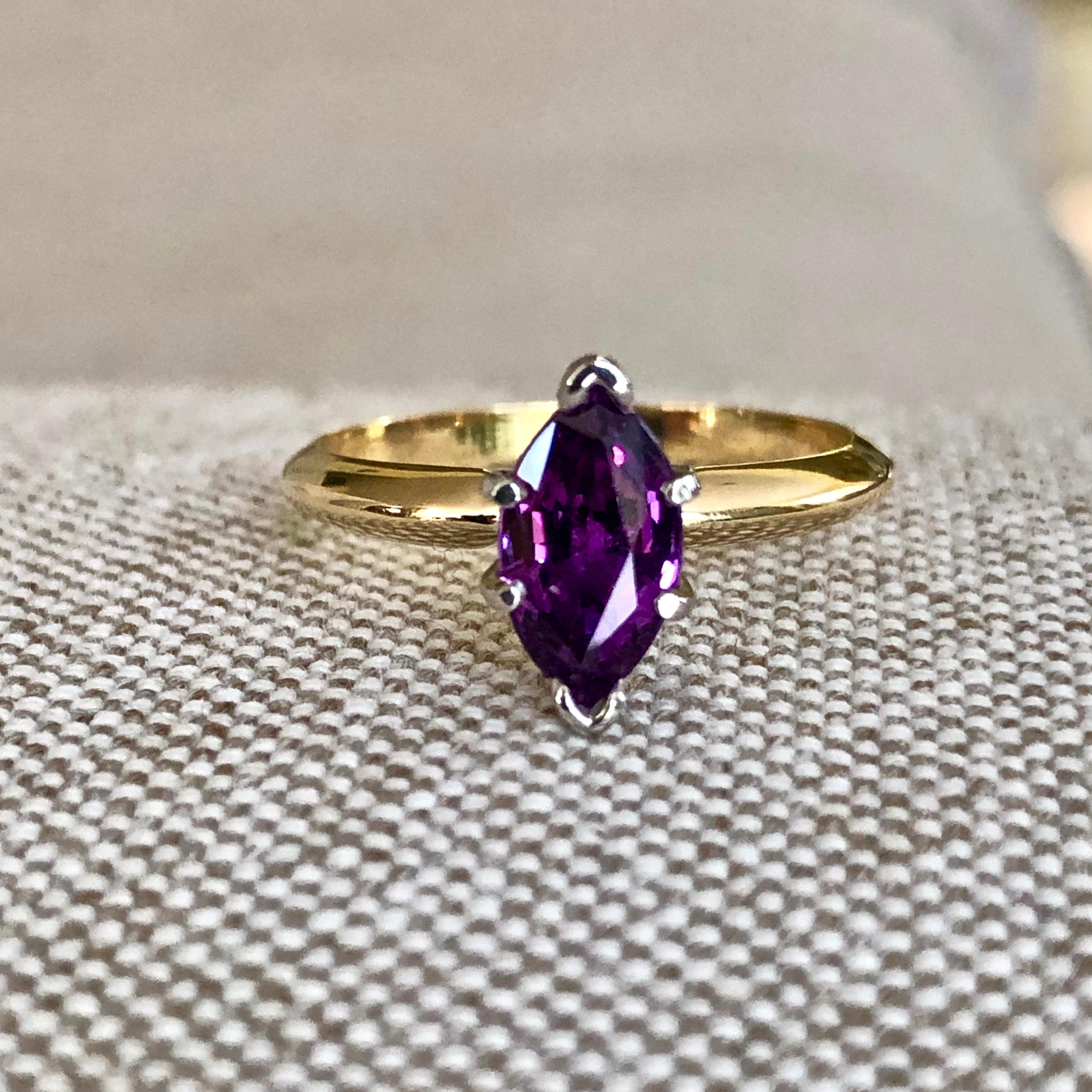 Natural purple sapphire marquise cut engagement ring. 18k yellow gold and platinum setting. 
1 Marquise sapphire total weight 1.39cts, Natural purple color, VS in clarity. 
Size 6.25 and sizable. 2.95 grams 
Estate/Excellent Condition