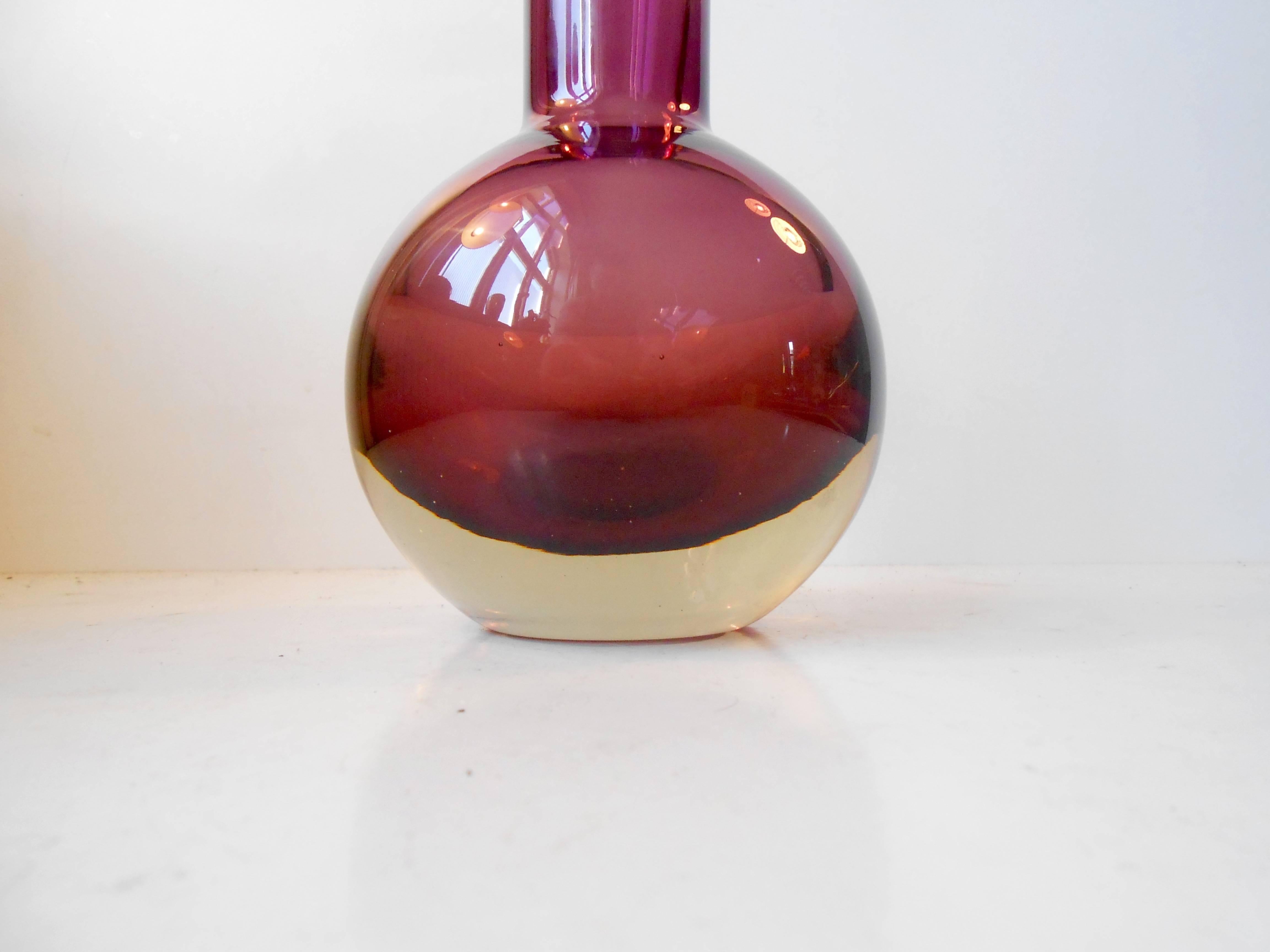 This purple glass vase was designed by Nanny Still and manufactured by Riihimäen Laso Oy in Finland in the 1950s. Mint condition. Signed to the bottom.