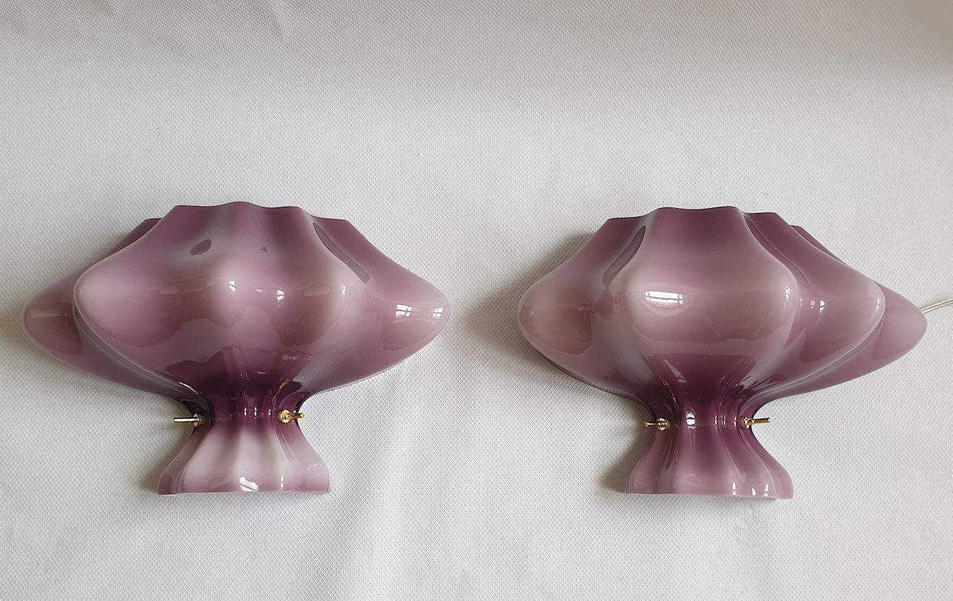Pair of Murano glass Mid-Century Modern wall sconces, Italy 1980s. Attributed to Cenedese.
The sconces are made of a single piece of Murano glass, from purple to light pink hues of color.
The glass has several layers, and is white inside. It makes