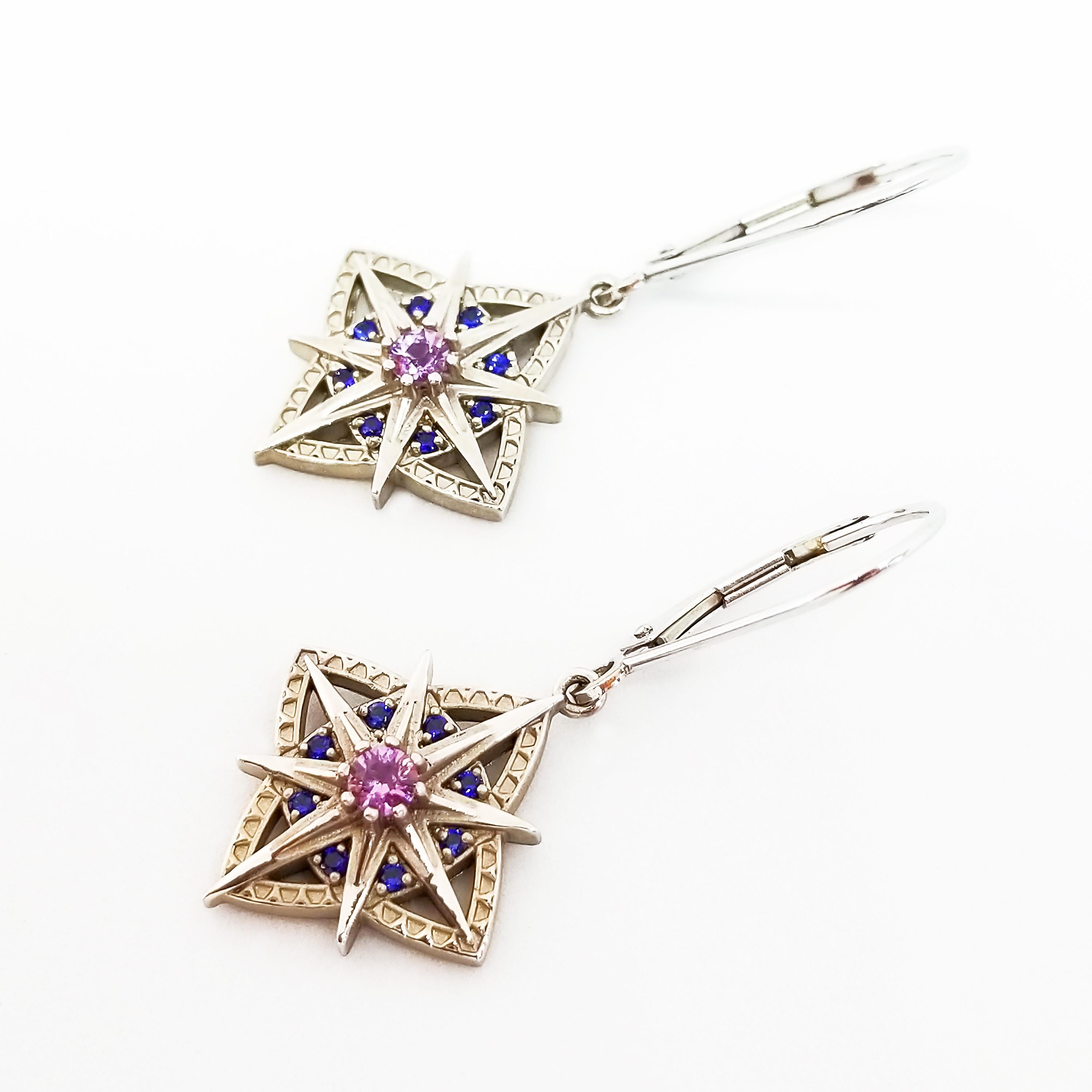 These Antique or Nautical Style Star Earrings feature eight pointed, Antique Styled Stars, and four petal, Clover Shapes set with Round Brilliant Cut, AAA Sapphires of Blue and Purple Pink.  The two Gem Quality center Sapphires are a Brilliant