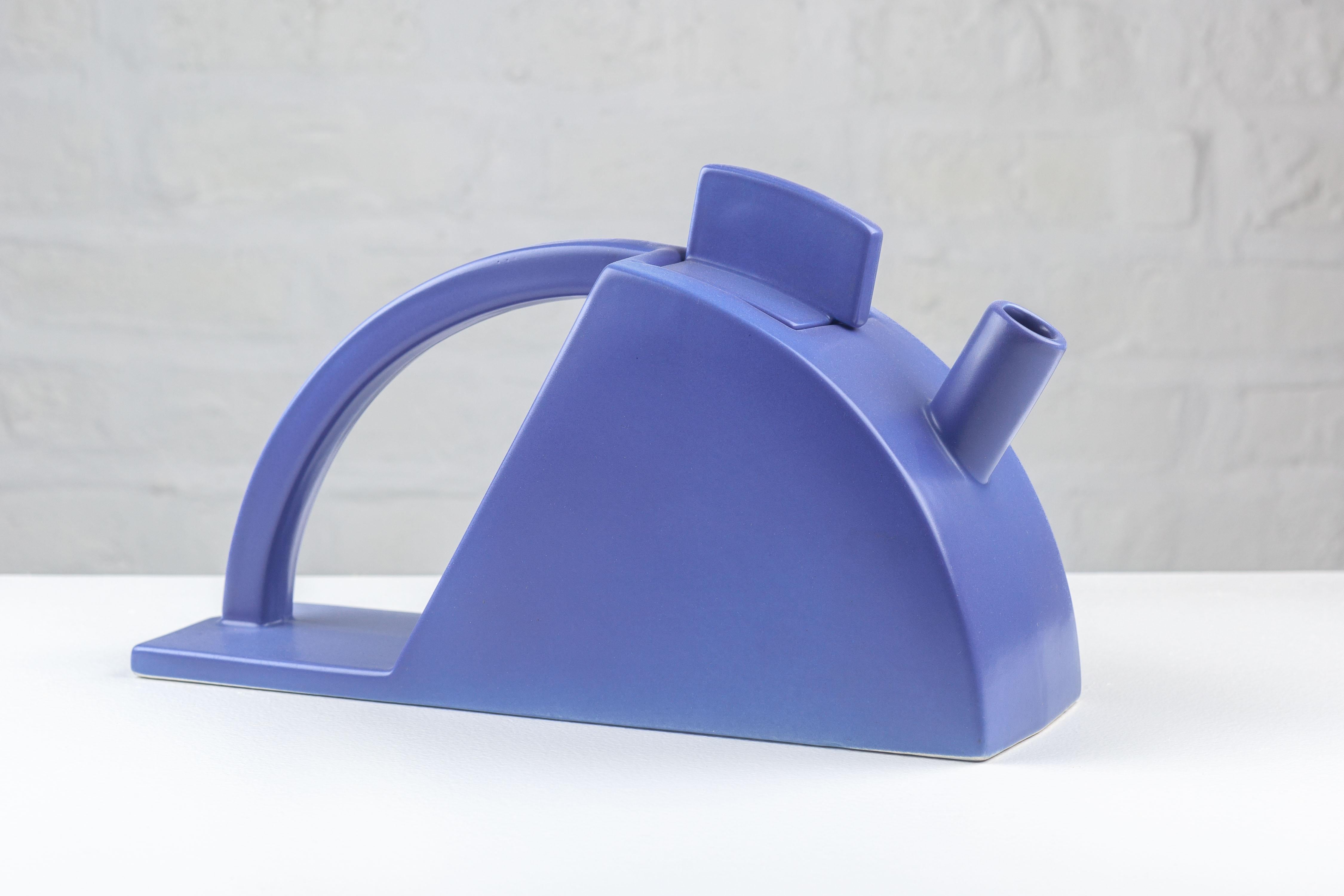 Purple tea pot designed by Pierre Casenove for Salins Studio, circa 1980s France. The body of the tea pot has the mass and energy of a streamline locomotive with its steaming spout, embodying an aesthetic of speed and power from the machine age. The