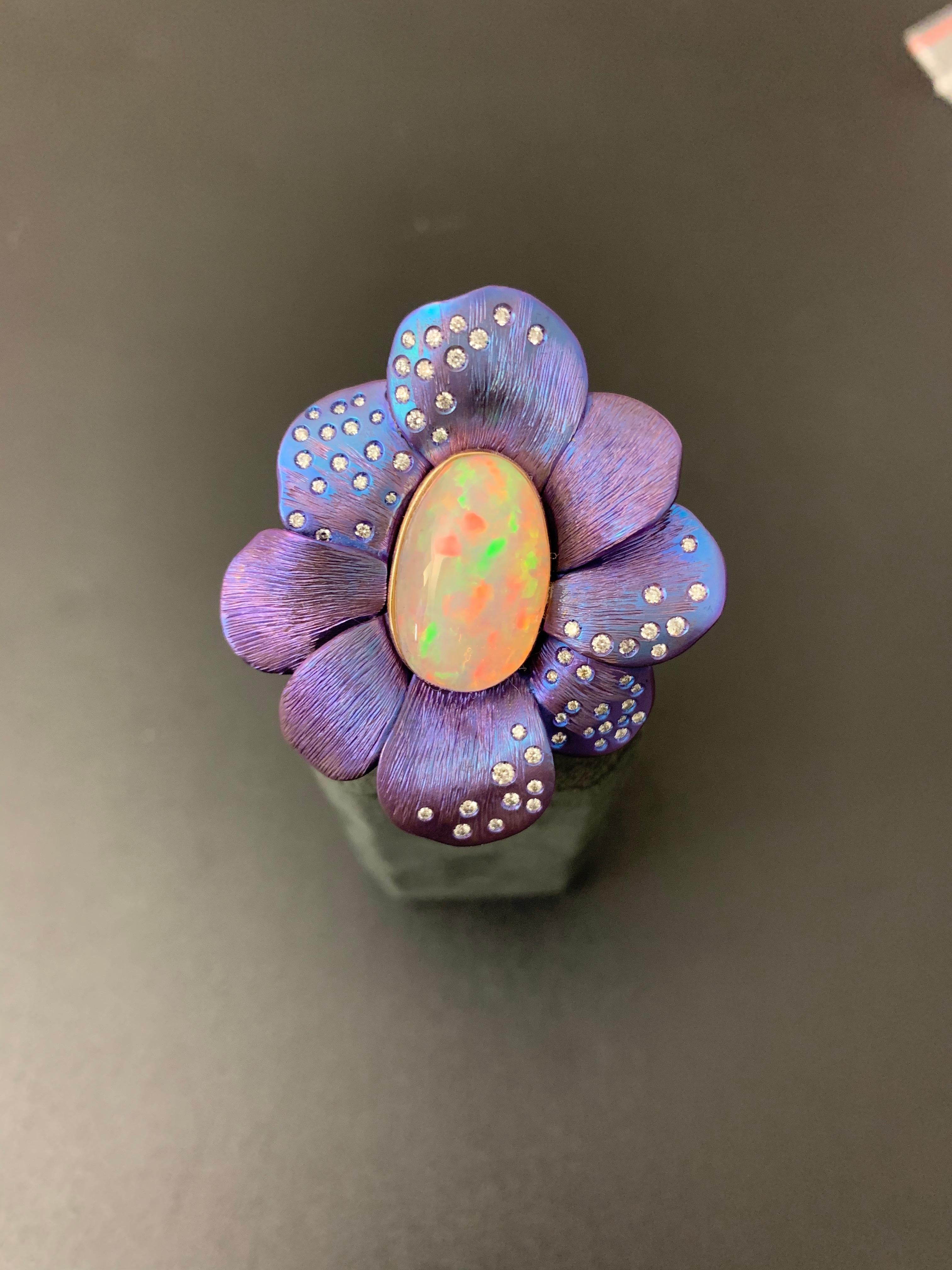 Titanium and Gold Opale diamonds Purple Ring 

Purple ring
Titanium & Gold 3.25 g 
71 diamonds brilliant cut 0.59 Cts
Opal oval shape 11.20 Cts 
Size 57 ( 17 )
Available now 

This flower titamium opal ring is a real eye-catcher and is perfect to be