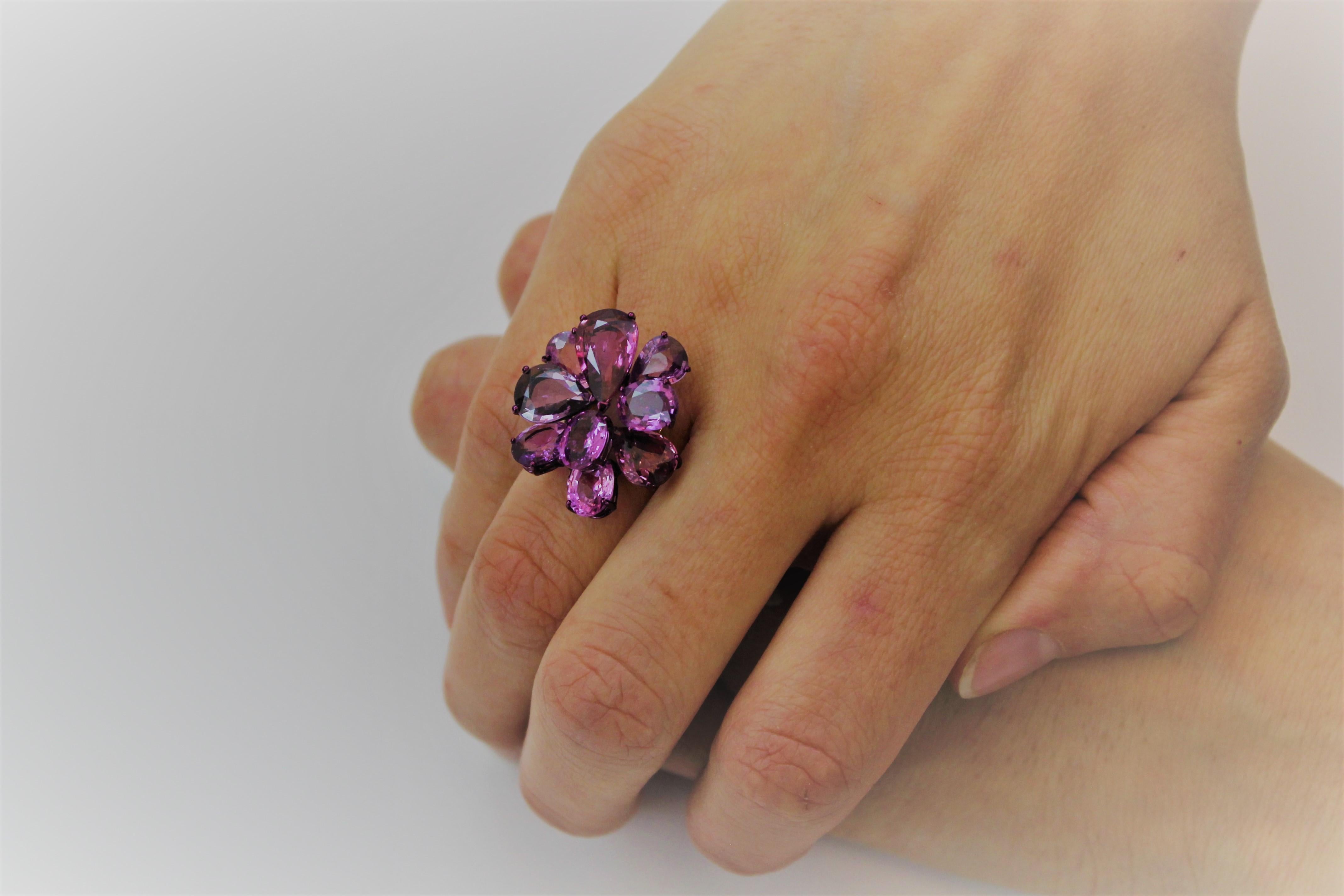 Refined and Elegant, this Cocktail Ring features 9 Purple Oval and Pear Shape Sapphires for 15.58 Carat total. 
The Purple Sapphires are set on multilevels to create organic volume. 
The Colour of Sapphire is enhanced by Purple E-Coating of the